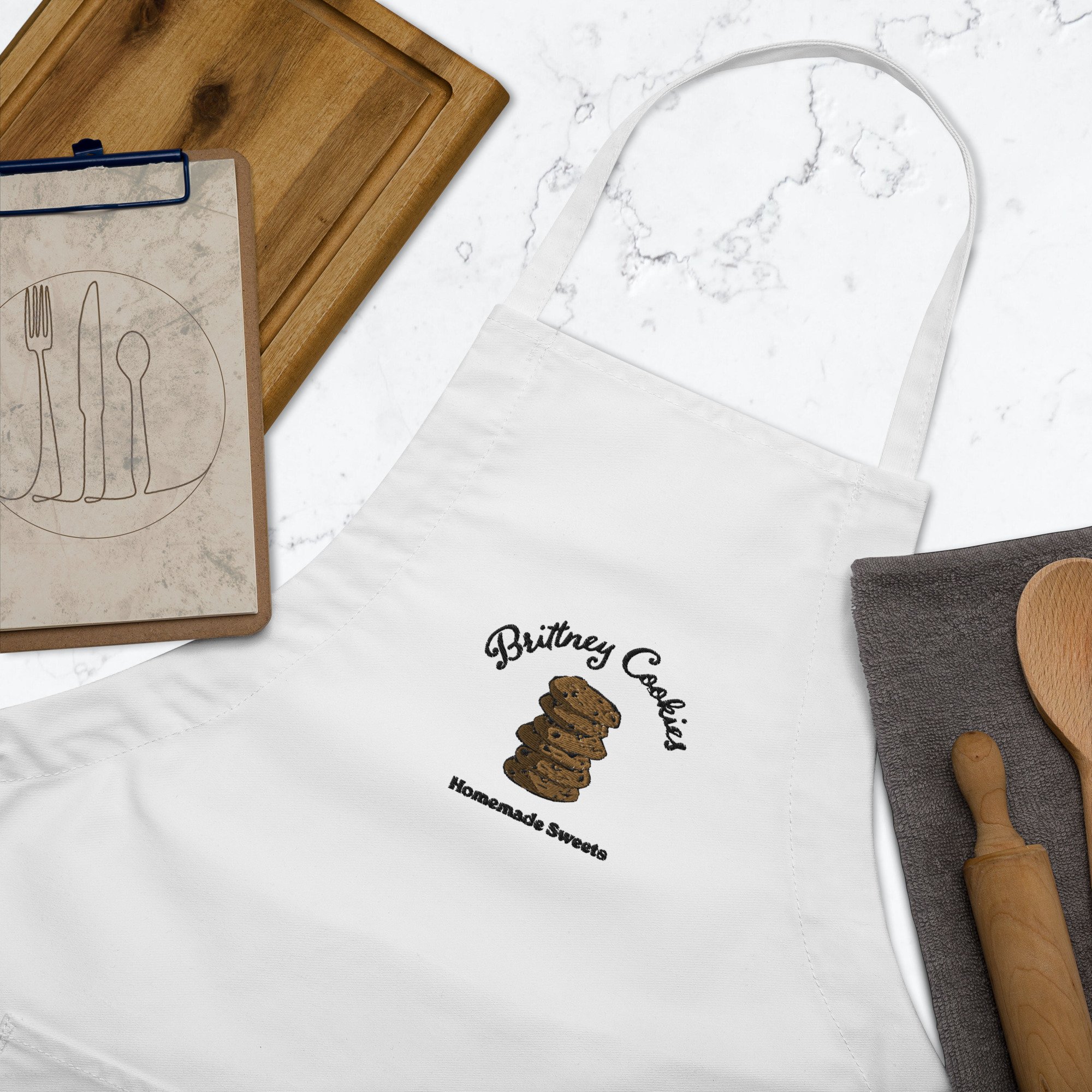 embroidered-apron-white-zoomed-in-6427277c6ec54.jpg