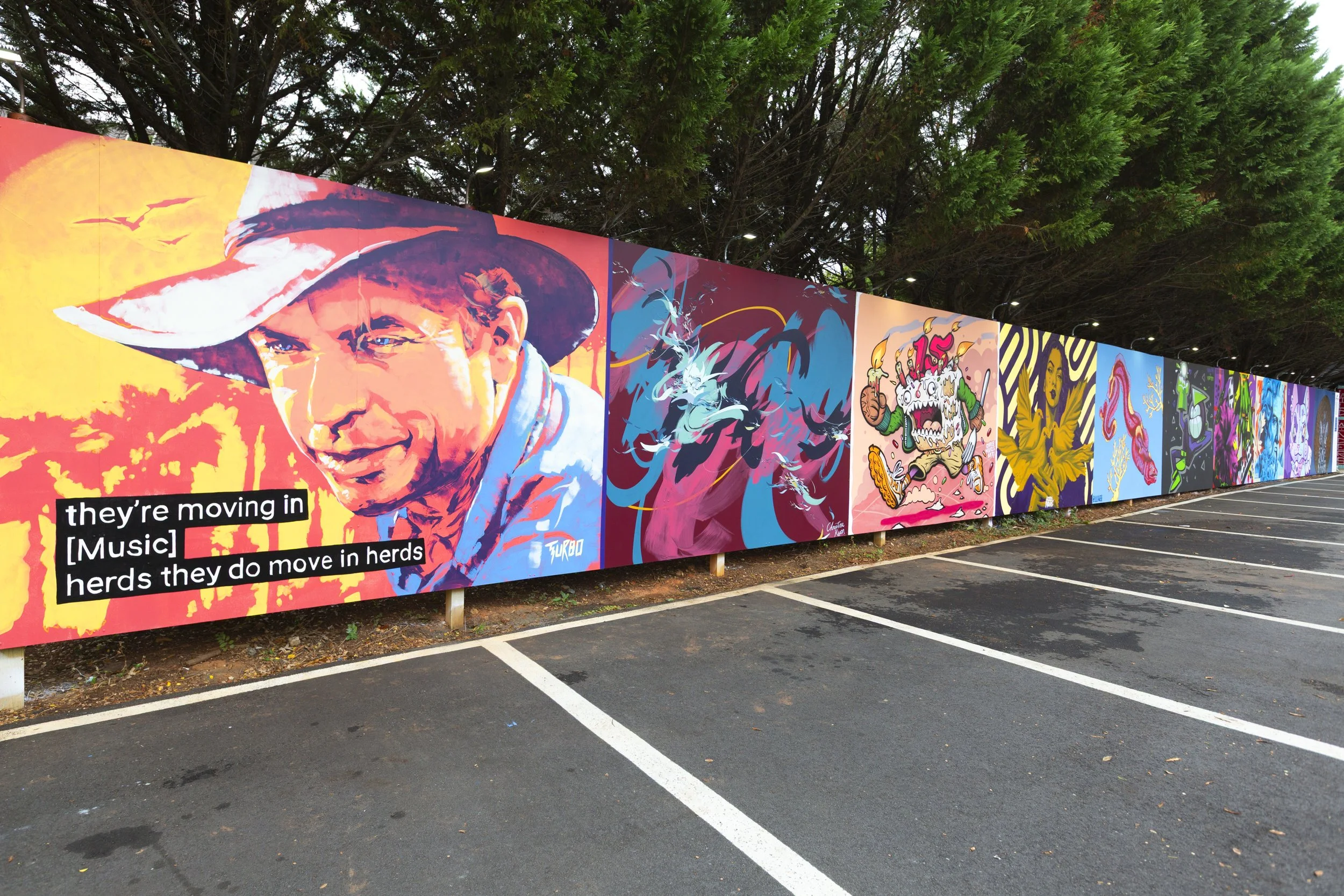 Panoramic mural walls at The Art Yard, an outdoor street art destination in Atlanta.