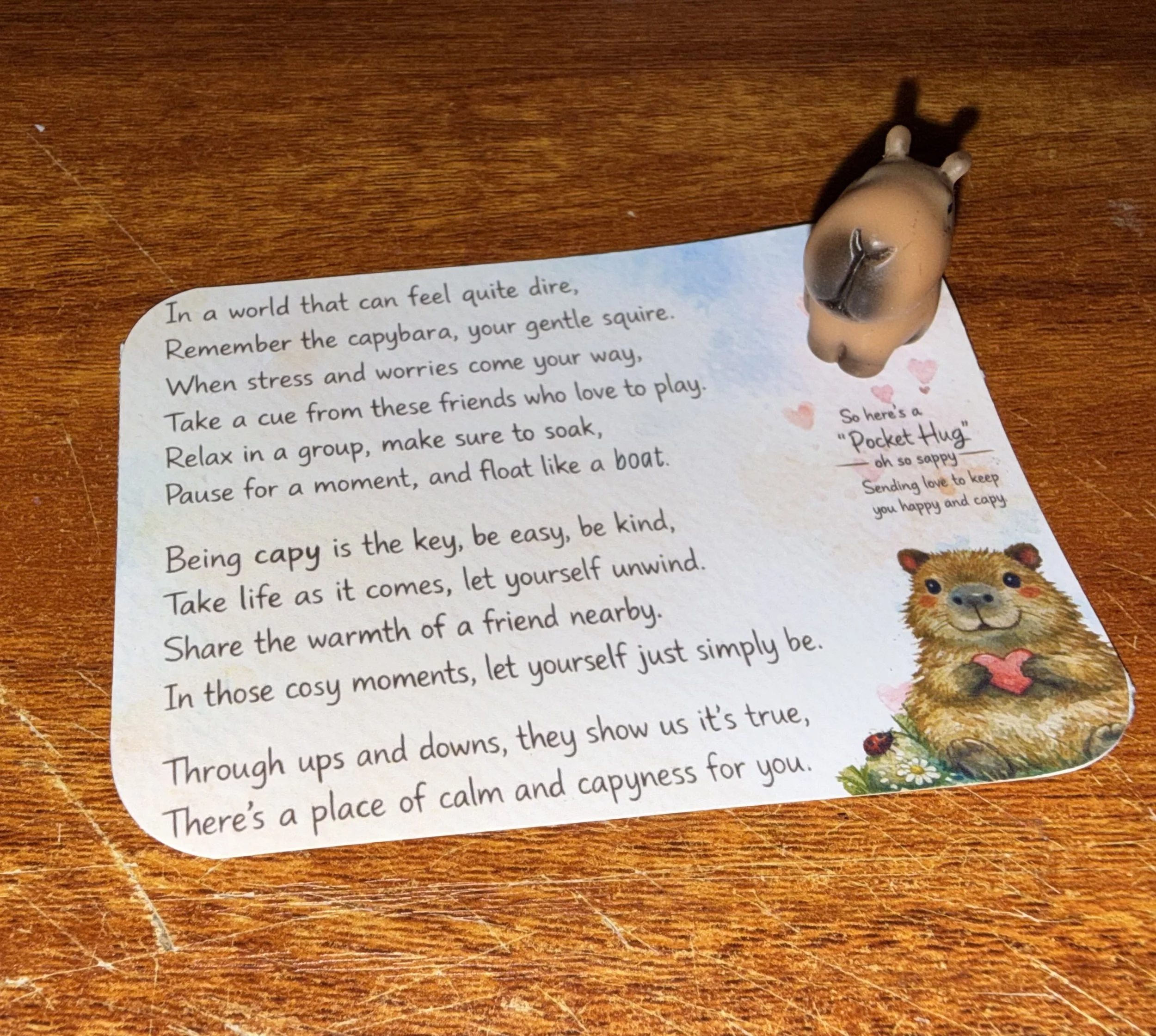 A  small animal figurine resembling a Capabara and a printed page with mental health poem