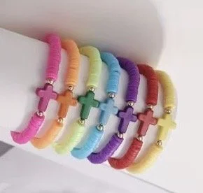 Colorful beaded bracelets with cross-shaped charms in pink, orange, green, blue, purple, red, and yellow, stacked together.
