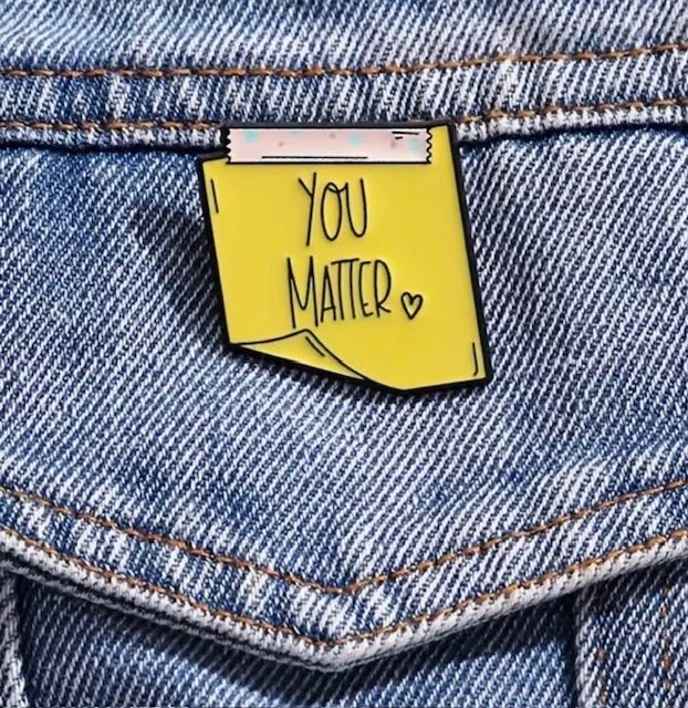 A yellow pin with the handwritten message "You Matter" and a small heart, mental health (Anchored Thoughts)