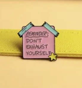 Pink sticky note shaped pin badge with the message 'Reminder: Don't exhaust yourself' Mental Health (Anchored Thoughts)