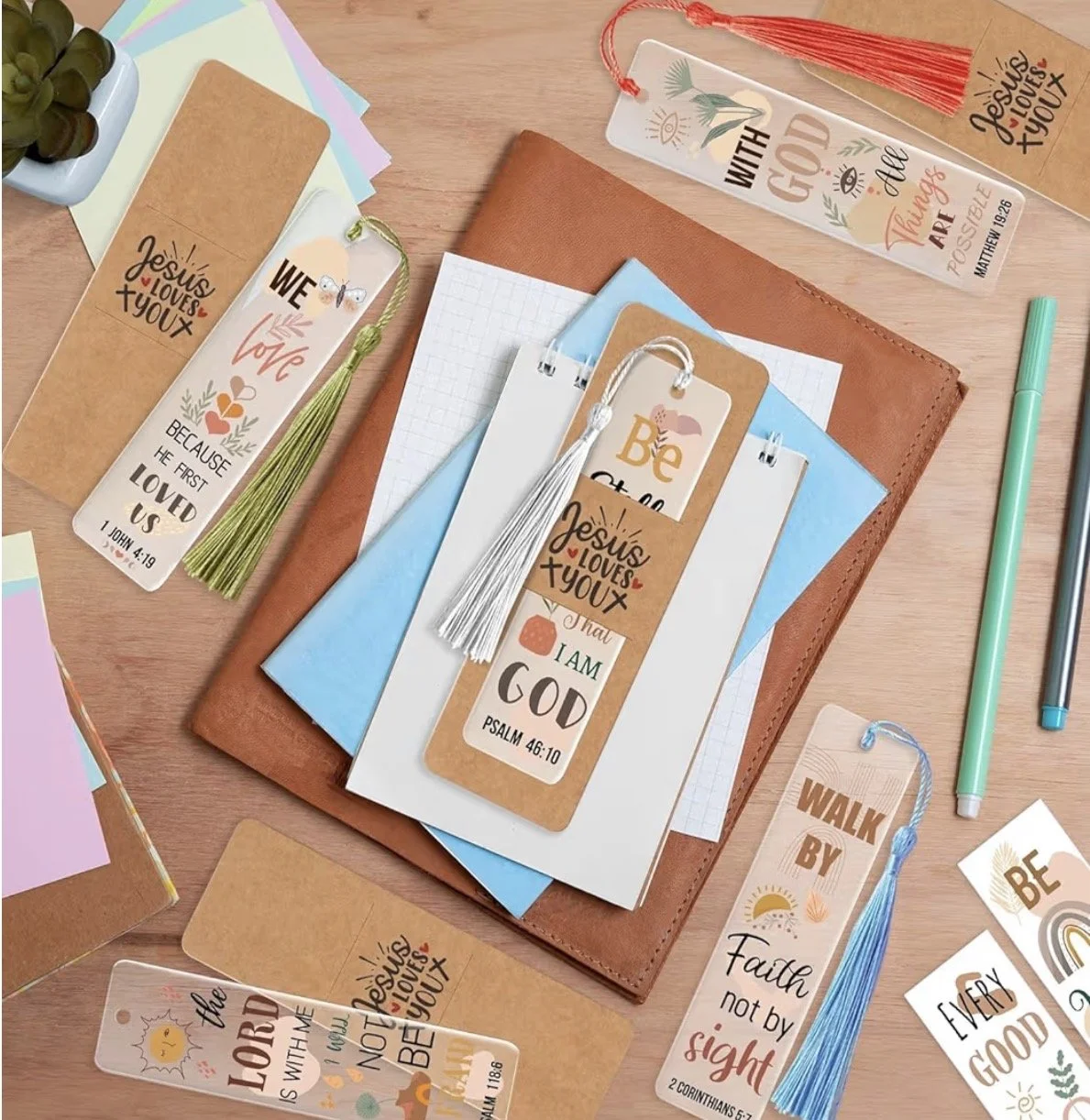 A collection of faith-based bookmarks with inspirational Bible verses, colourful tassels, including notebooks and pens. Mental health