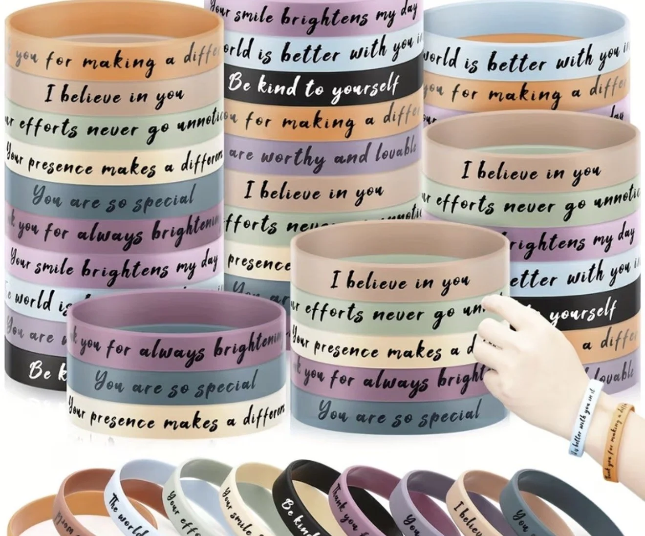 Colorful silicone wristbands with inspirational and motivational messages, stacked and displayed in various colors.