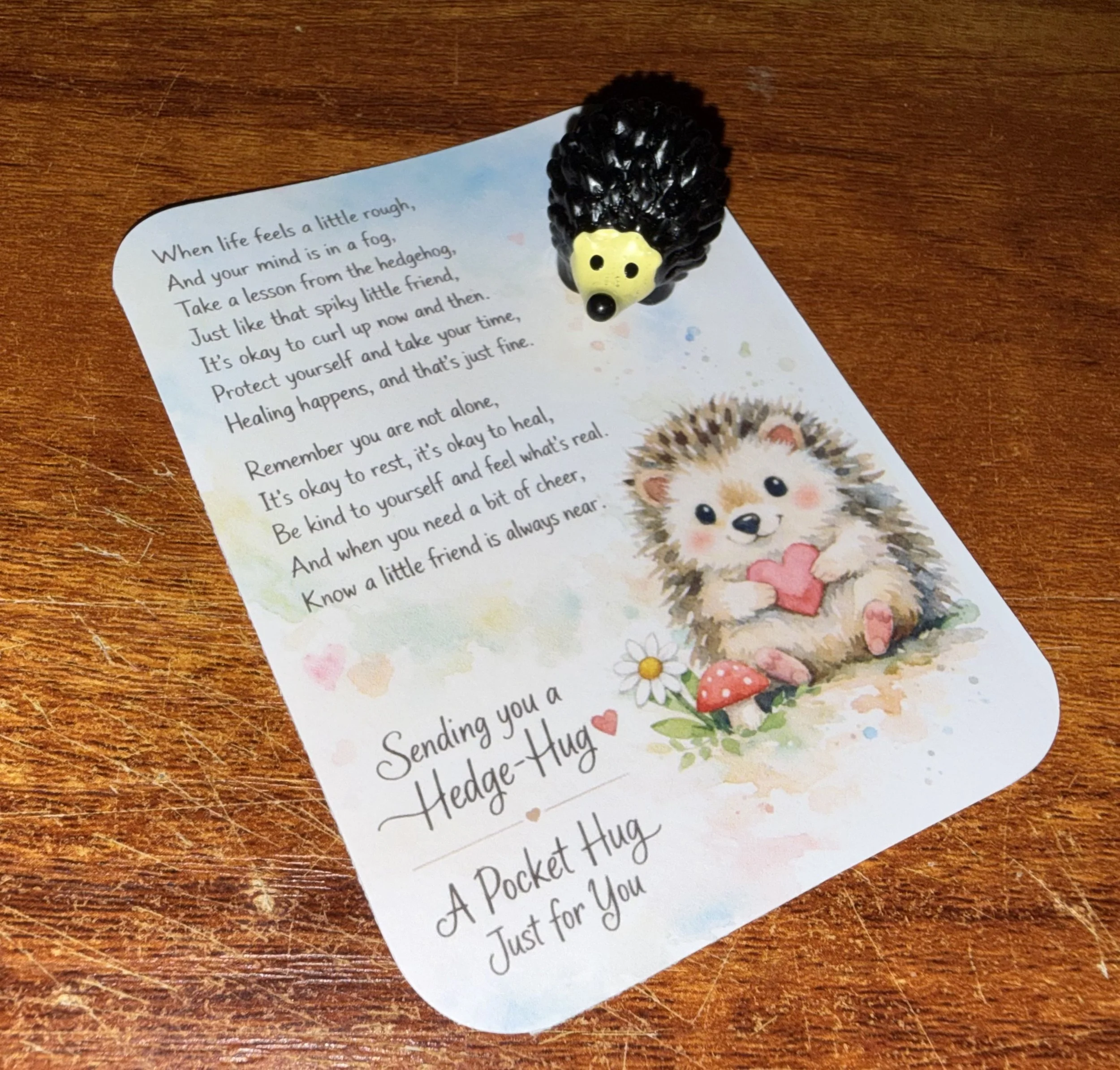 A small plastic hedgehog figurine. The paper has a poem about life, healing, and support. Mental Health