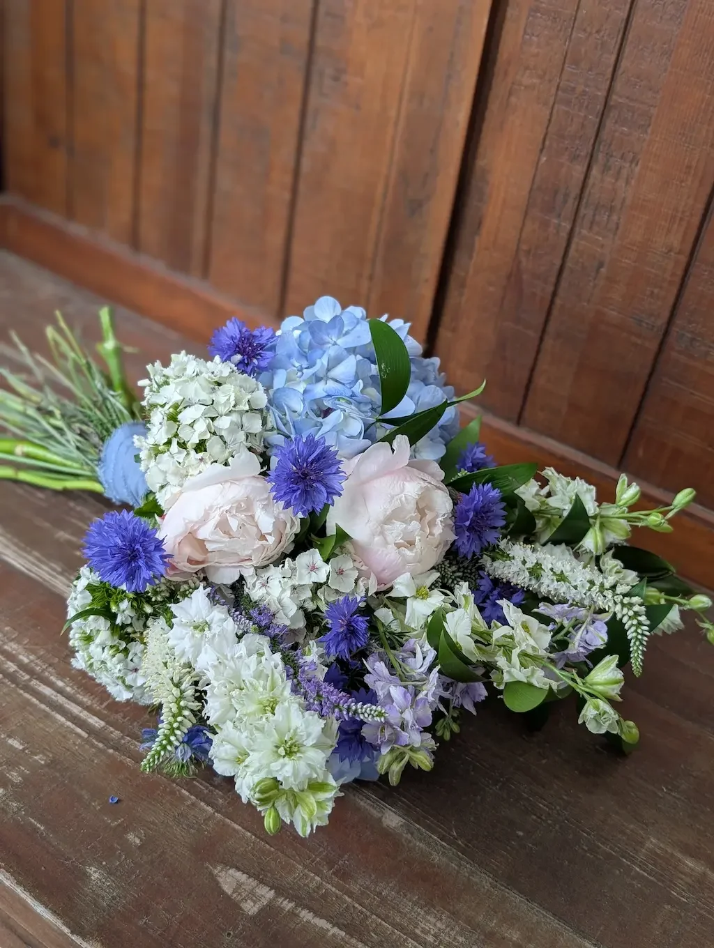 Custom summer bridal bouquet featuring vibrant blue cornflowers, white delphinium, and fresh-cut field stems by Breemar Flower Farm, a premier wedding florist serving the Richmond, VA area.