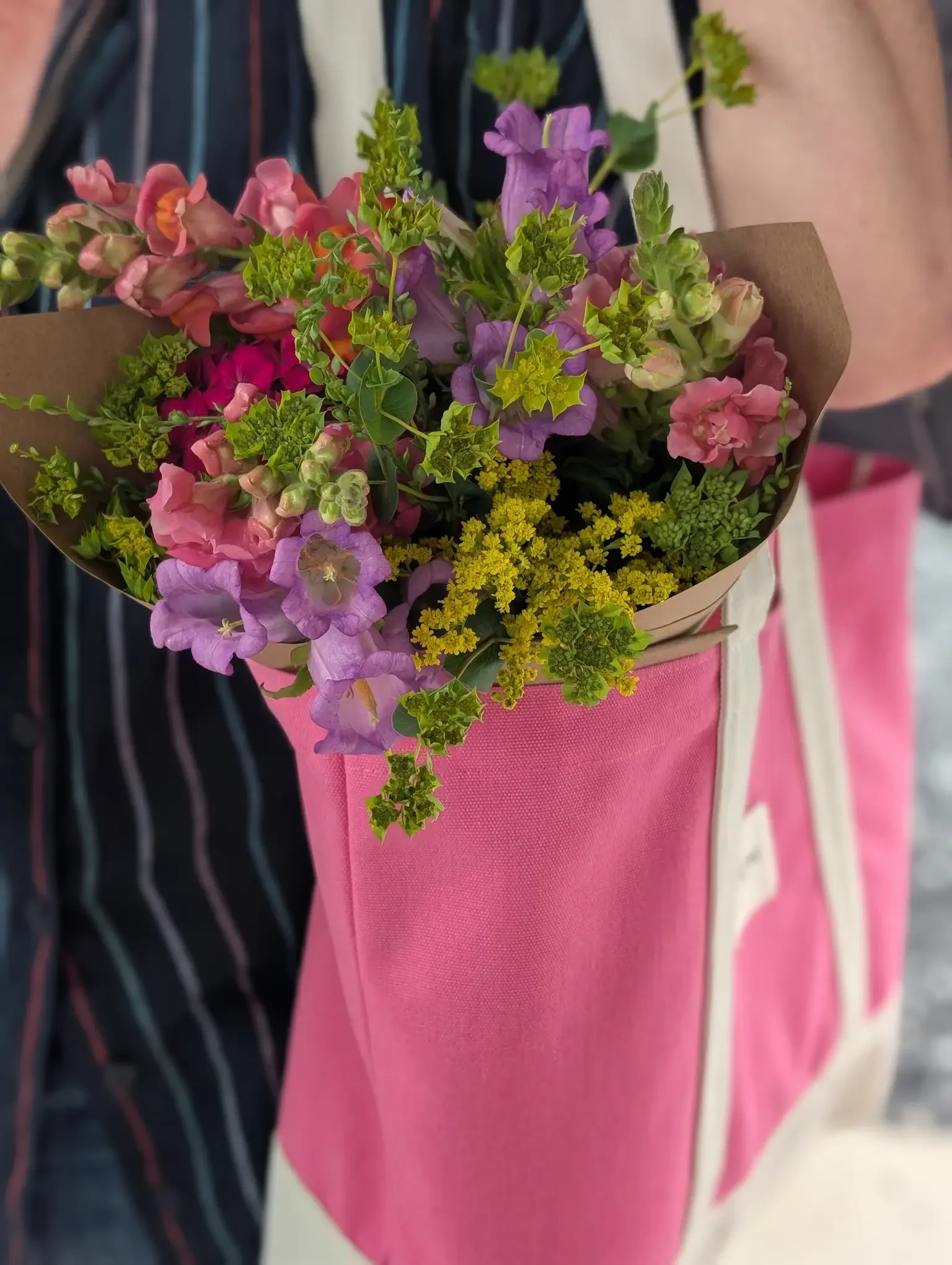 Vibrant summer flower subscription bouquets wrapped in kraft paper featuring fresh-cut zinnias and snapdragons from Breemar Flower Farm in Ashland, VA.