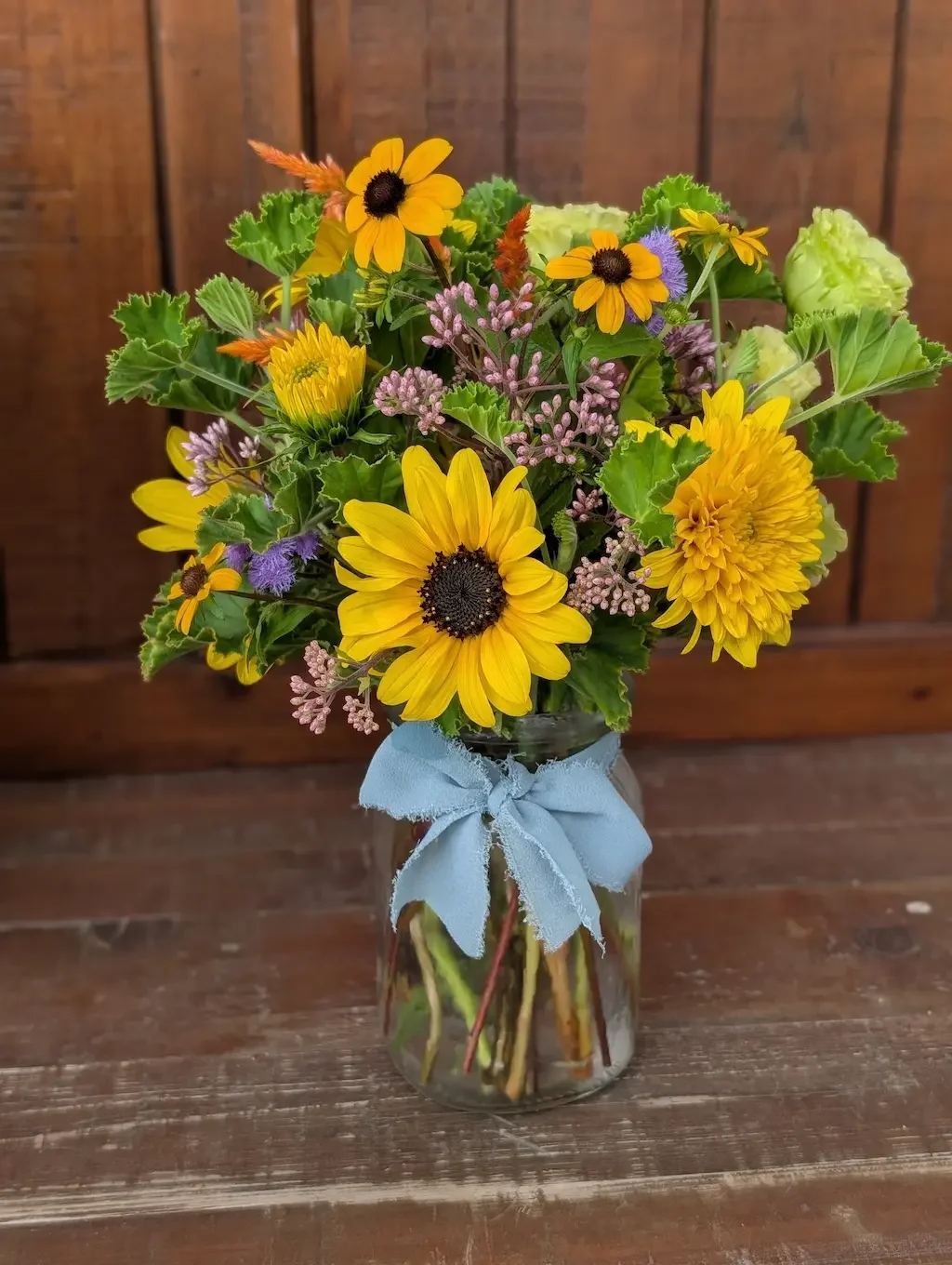 Small 15 to 25 stem DIY wedding floral arrangement with bright sunflowers and seasonal blooms for a Virginia reception table