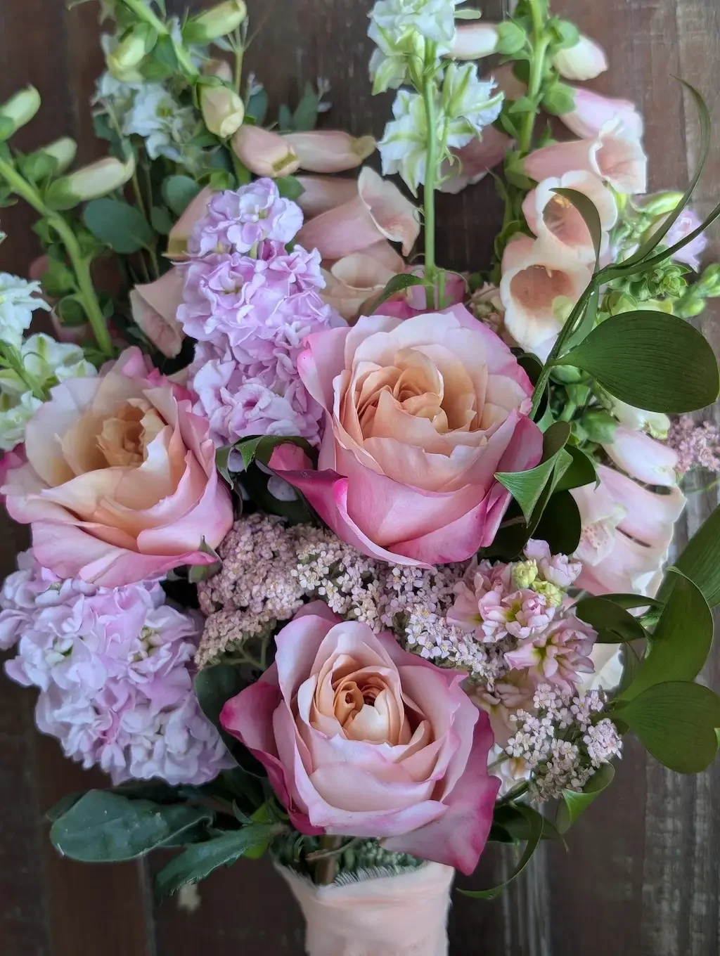 Elegant garden-style wedding flowers featuring premium blush roses, lavender foxglove, and seasonal texturized blooms designed by Breemar Flower Farm, an à la carte wedding florist in Ashland, VA.