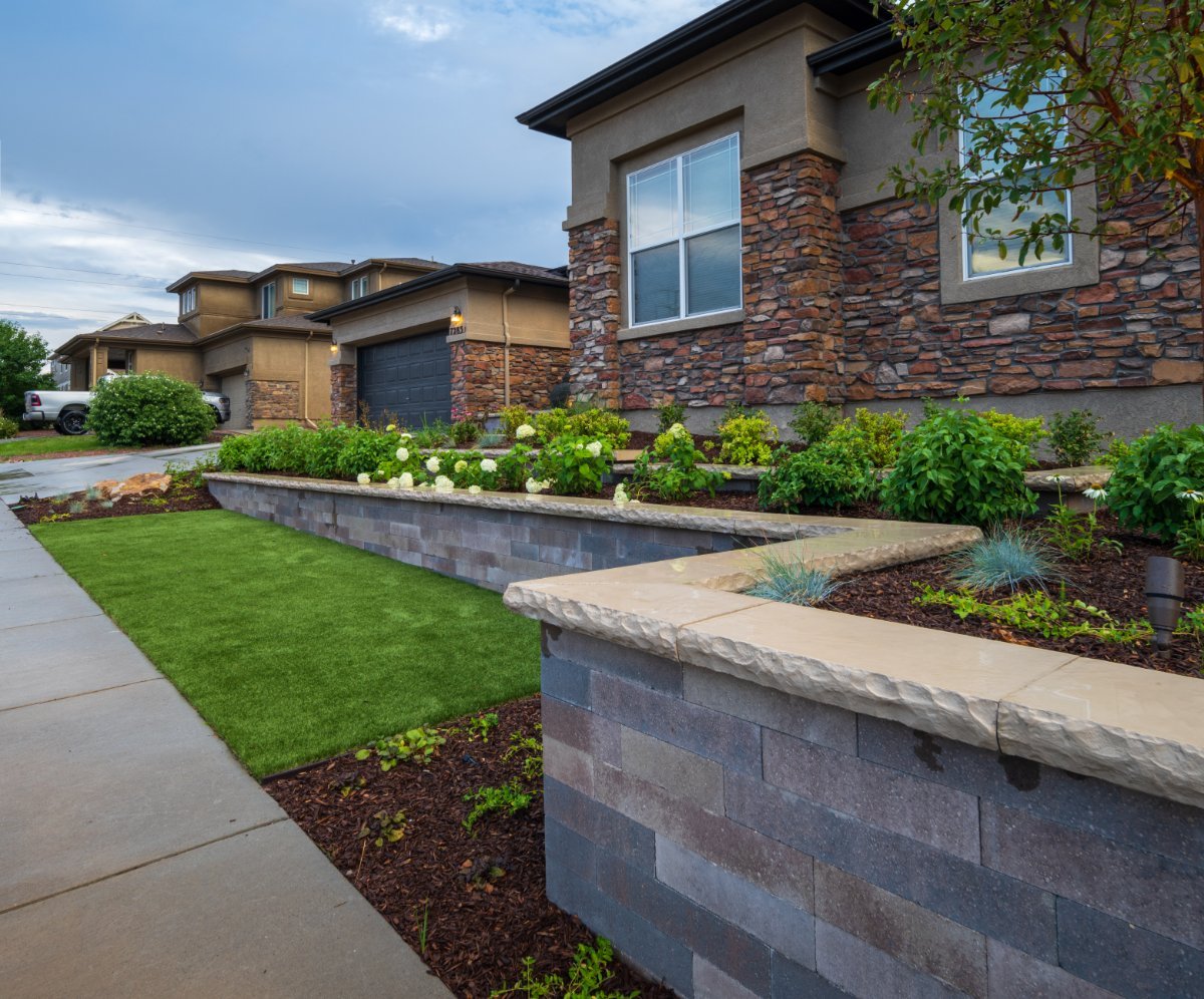 Landscape design with plantings and retaining wall in Castle Pines, CO