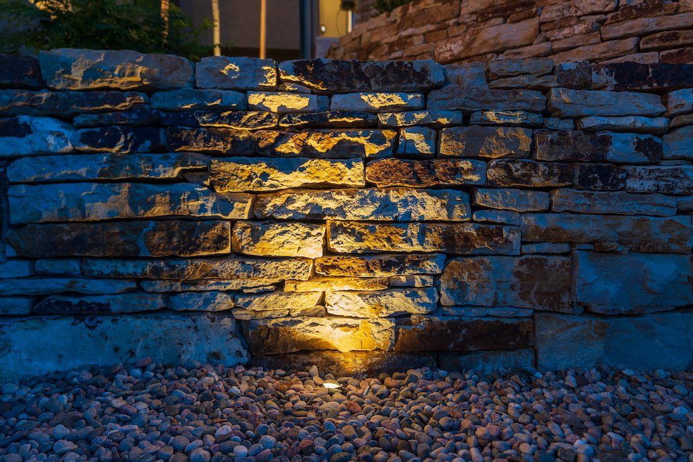 Retaining wall with landscape lighting in The Pinery, CO