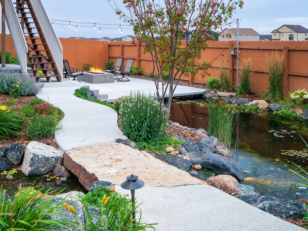 Stunning landscape design with pond in Northgate, CO