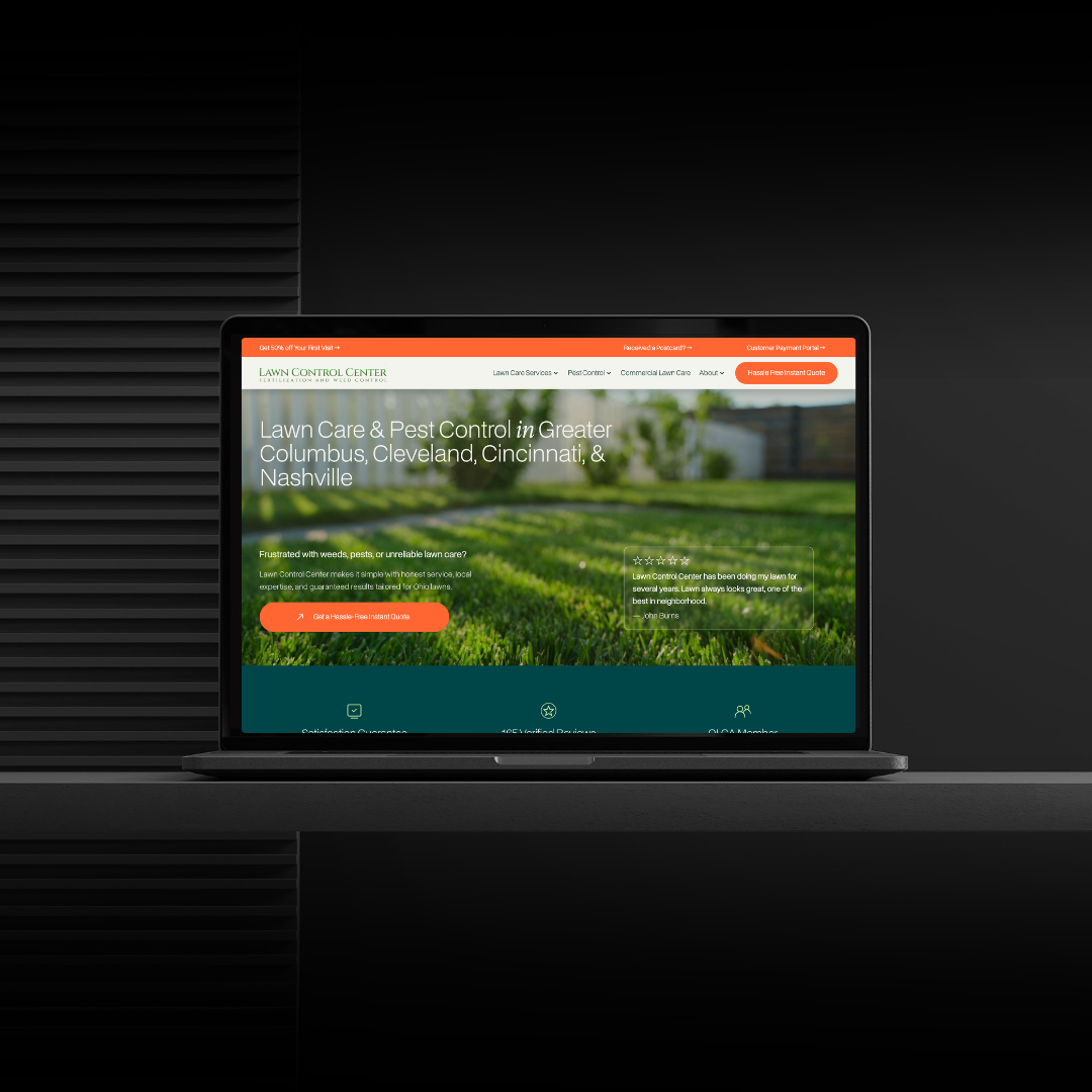 Laptop displaying a lawn care and pest control company's website against a black background.