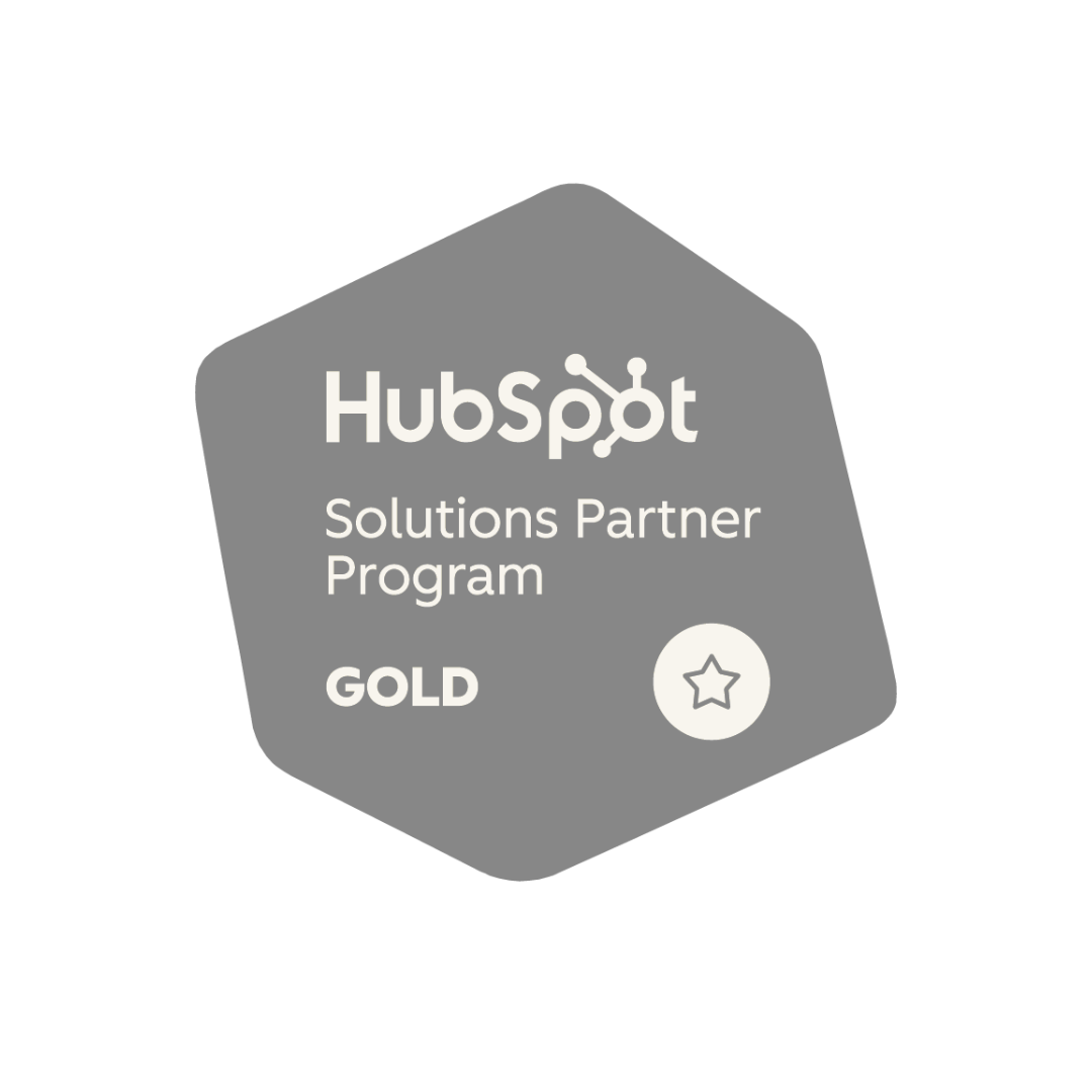 Gray badge with the HubSpot logo, labeled 'Solutions Partner Program - GOLD' with a star icon.