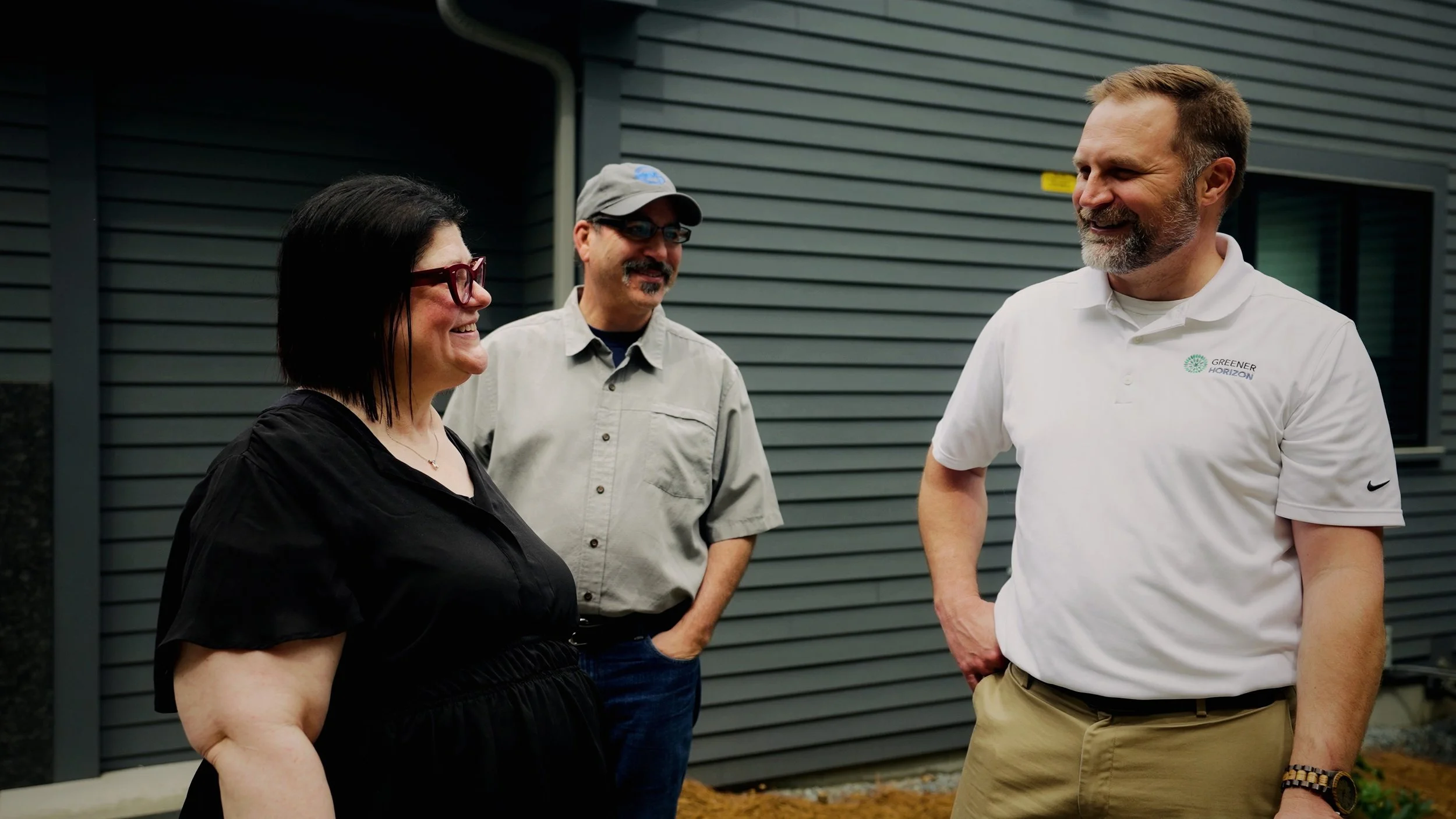 The $10M ComLandscaping company team members talking outside a residential propertypany Was Not Built to Become a $30M Company