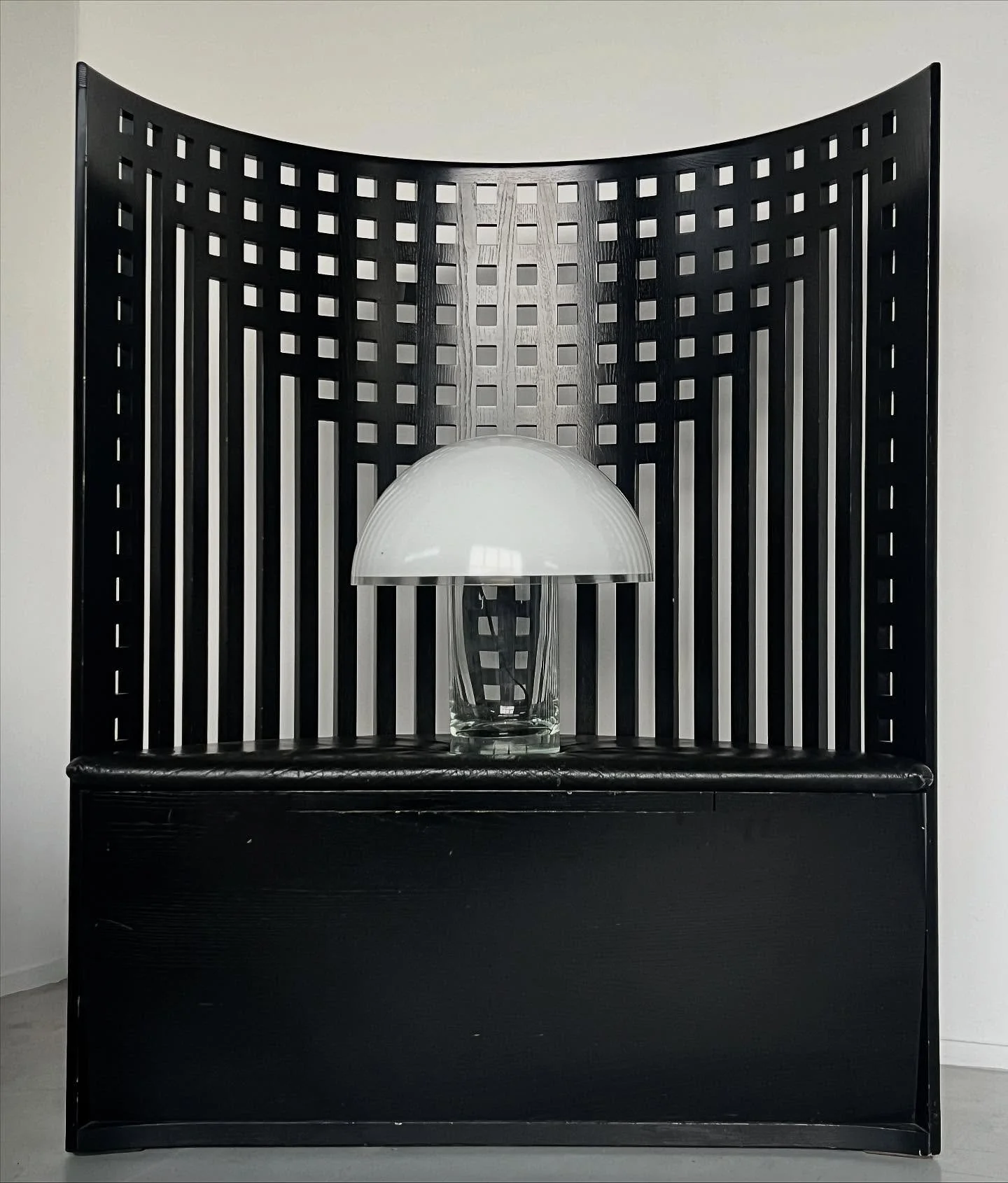 New: A sculptural table lamp with a cylindrical clear glass base and a wide domed white glass shade. Its clean geometry and contrasting materials create a striking silhouette, characteristic of 1970s modernist Italian design. Both functional and atmo