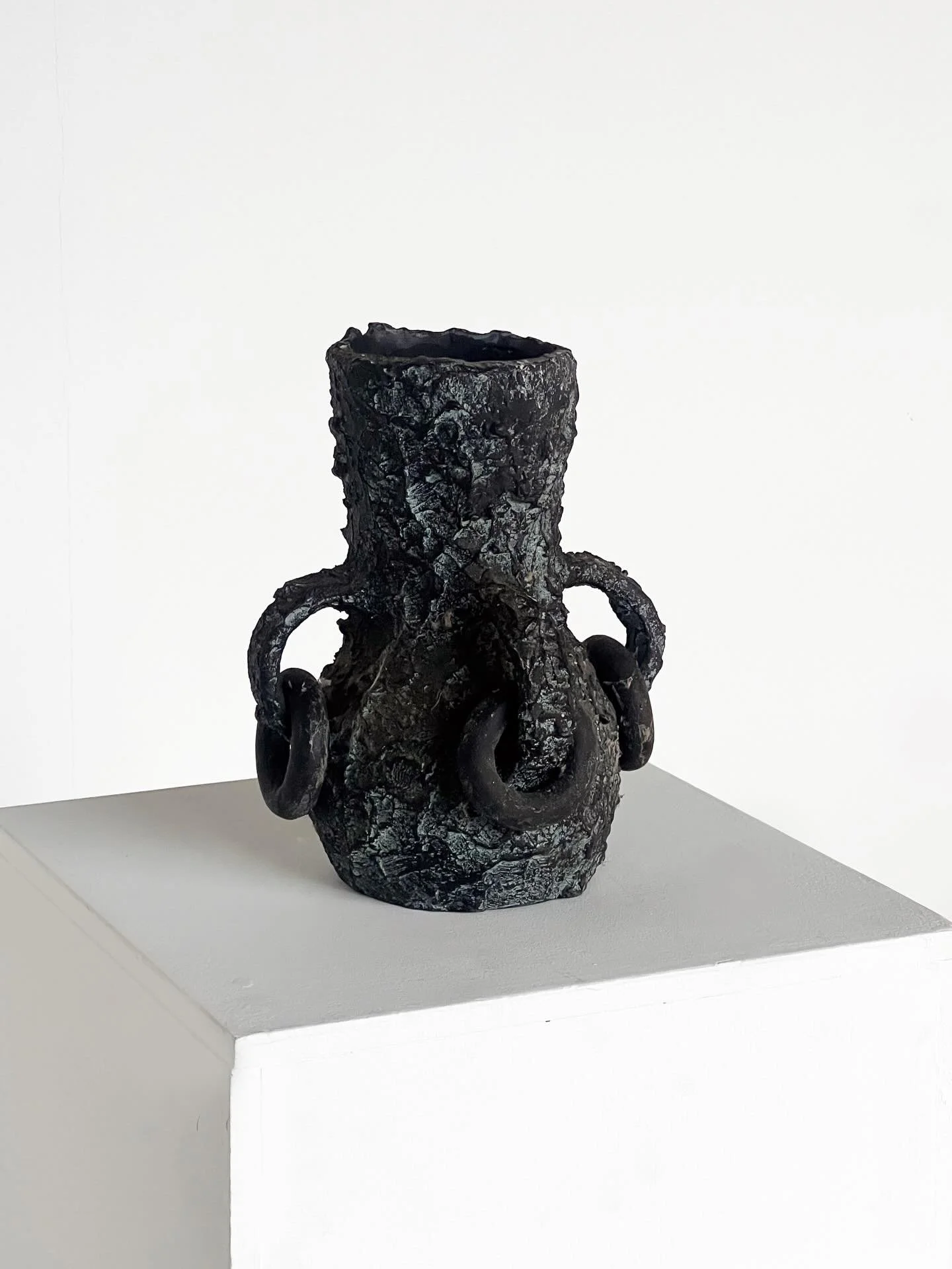 Handled relief vase: Mid-20th century, Brutalist

A ceramic vase exposing a  beautifully raw, tactile hand finished surface. A cylindrical neck and four looped handles with hoop decoration are integrated into the body, giving the piece an individual,