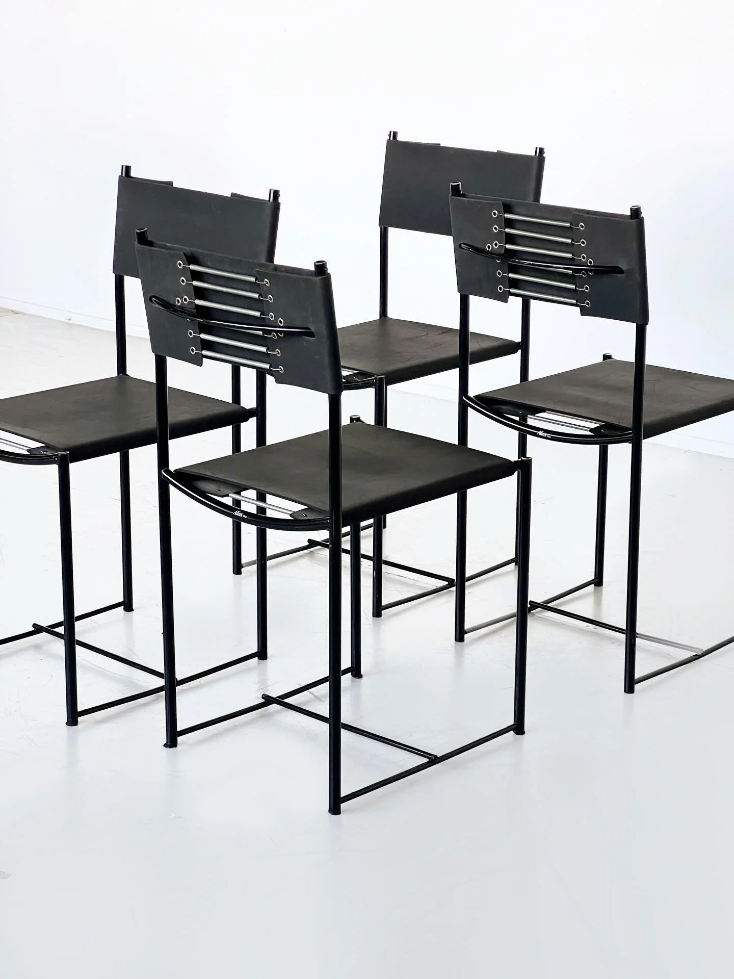 New: Black rubber and spring back corseted chairs by Giandomenico Belotti.

Alias&rsquo; story began in 1979 with Giandomenico Belotti&rsquo;s Spaghetti chair. These chairs feature a black enamelled steel base with seats and backs in black rubber. Co