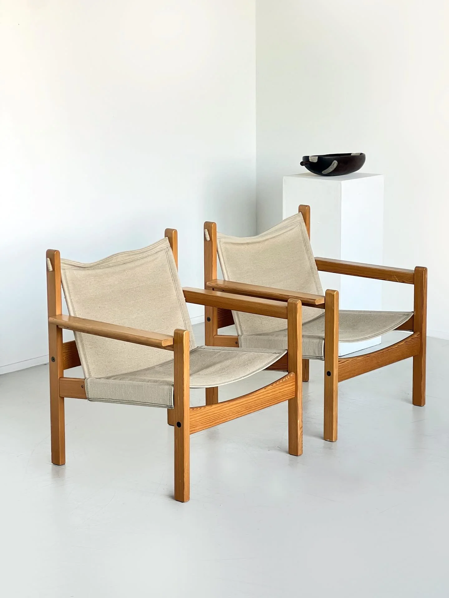 Now Sold: A pair of solid pine lounge chairs with suspended canvas sling seat and back. Defined by their honest frame and restrained silhouette, the design balances utility with warmth through exposed joinery, softened lines and natural materiality.
