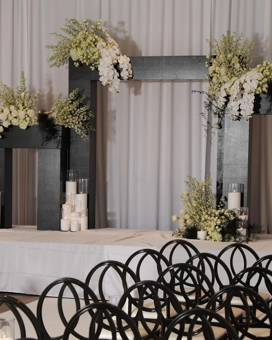 A bold frame for a beautiful beginning. 🖤

Architectural black lines, cascading white orchids, soft ivory blooms, and candlelight. This ceremony setting brings structure and romance together with exquisite detail.

Swipe closer, then save this for y
