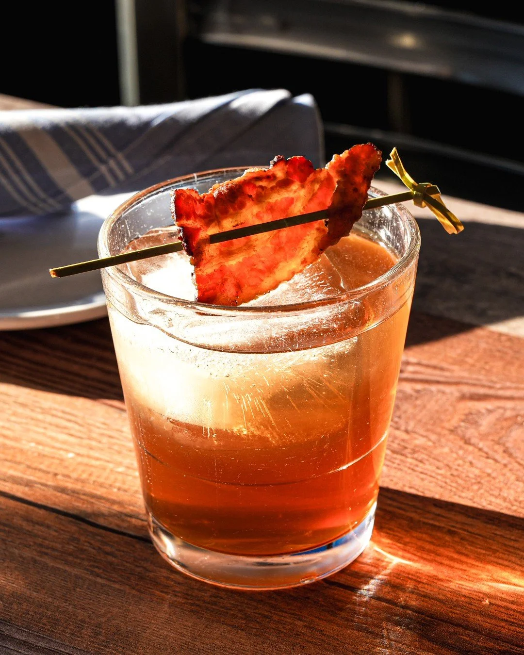 Meet your new winter favorite: the Maple Bacon Old Fashioned 🥃✨

Crafted with 99-proof bourbon bacon-washed for rich, smoky depth, sweetened with real maple syrup, and finished with black walnut bitters &mdash; all topped with a slice of candied bac