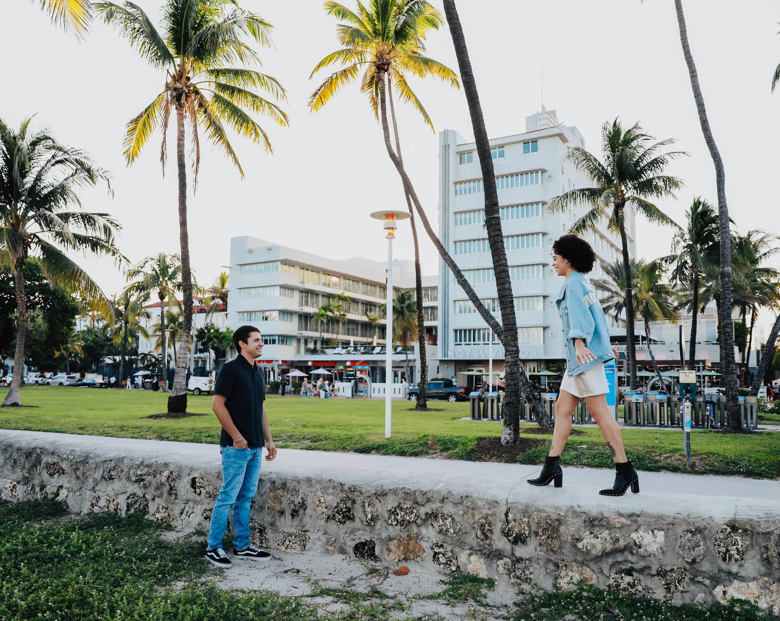 Couple walking near palm trees in Miami