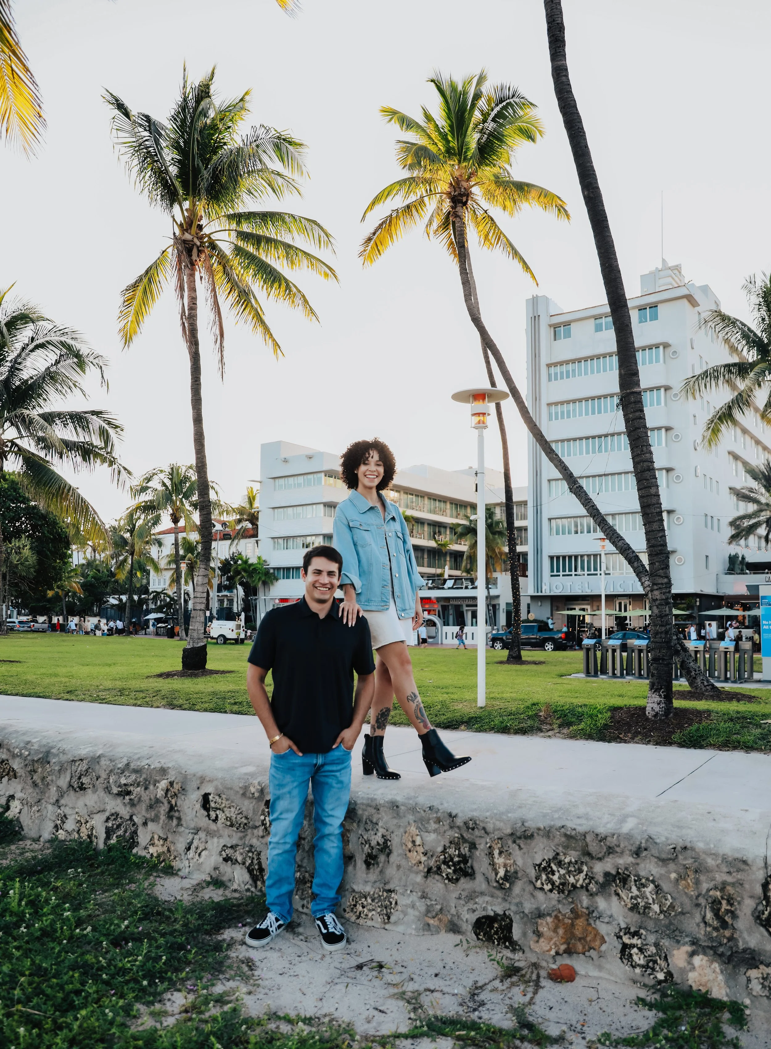 Couple walking through tropical city park