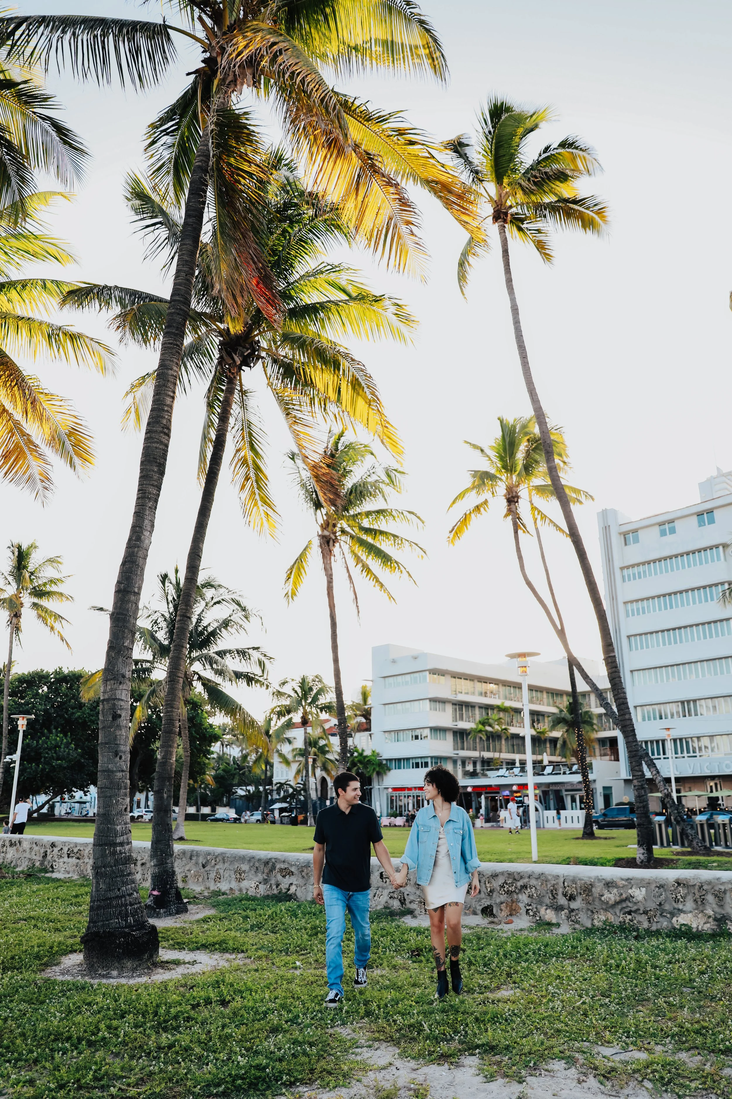 Palm trees and couple walking in tropical setting