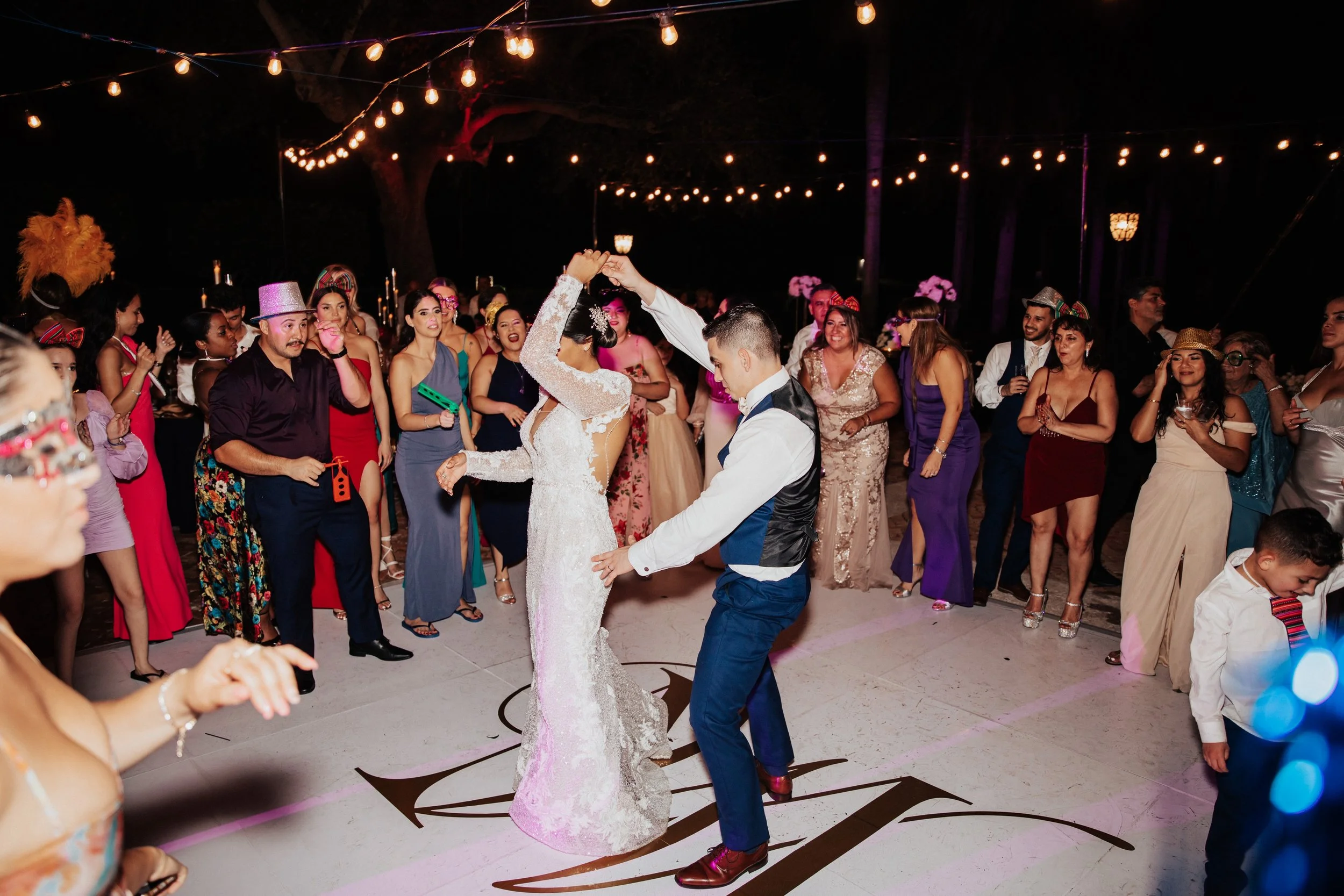 Bride and groom dancing with guests in party atmosphere