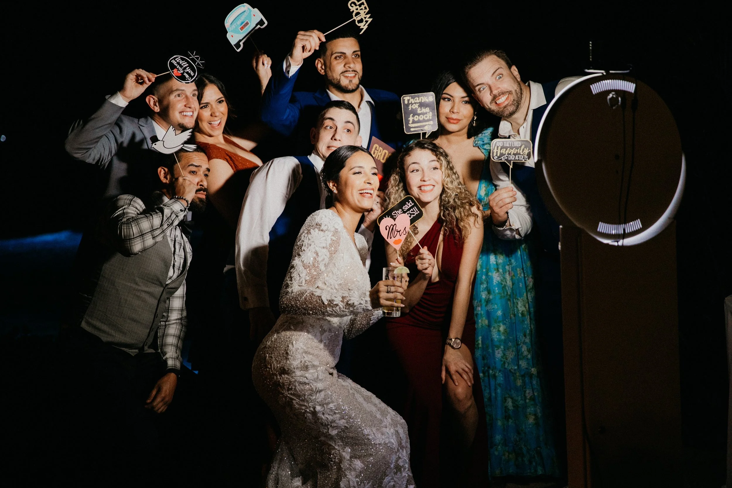 Wedding guests posing for fun group photo at reception