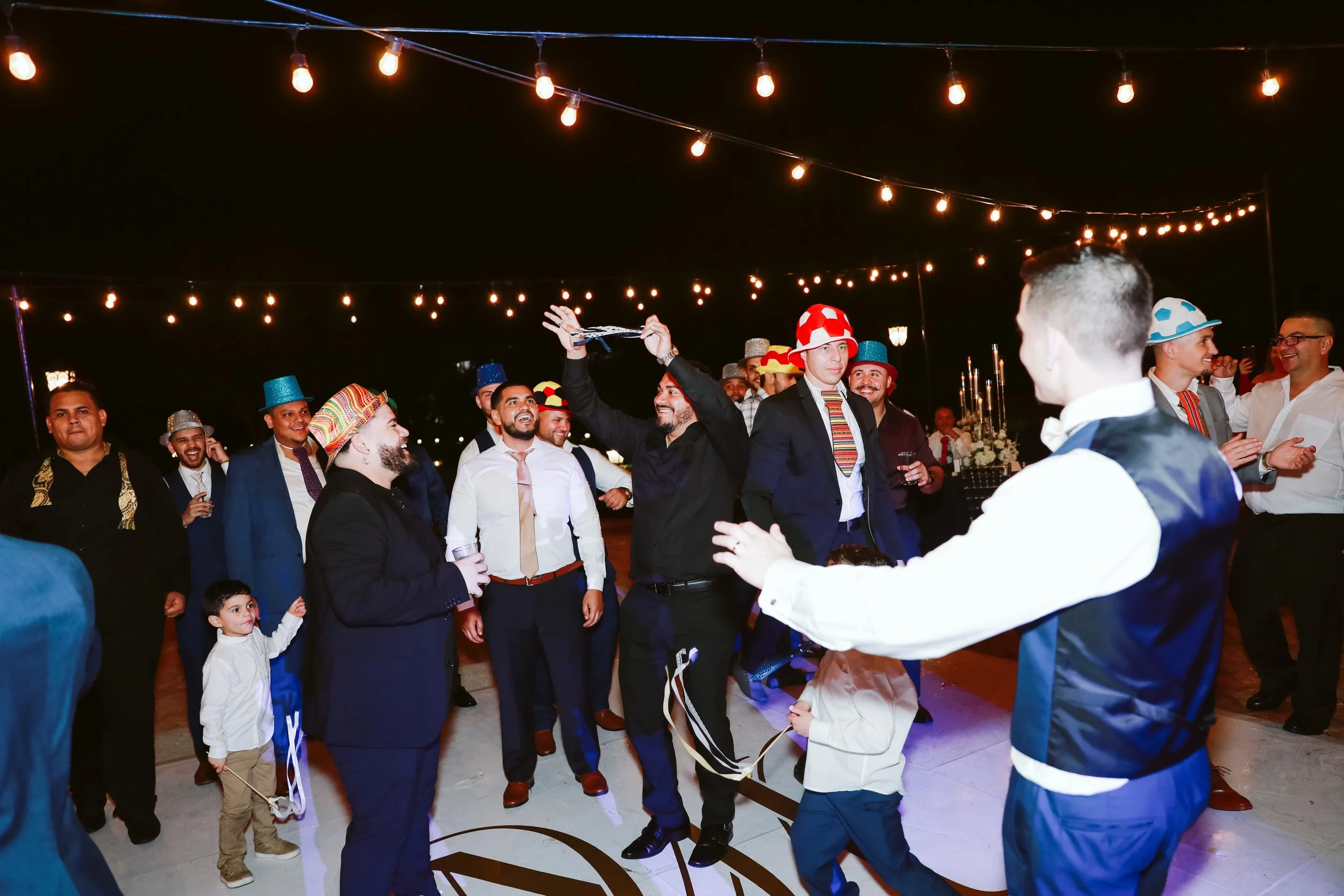 Groom dancing with guests in fun wedding moment