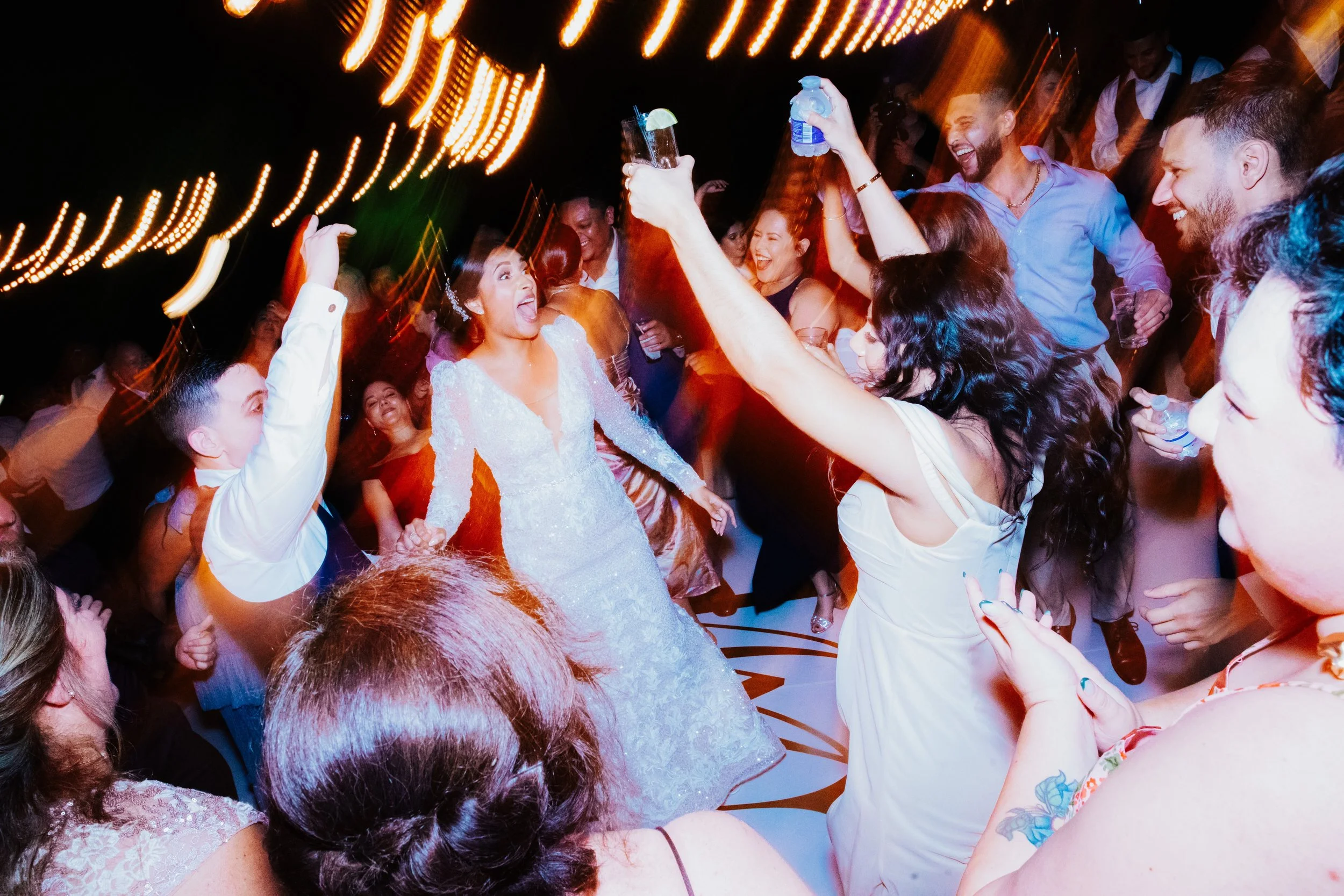Wedding reception party with crowd cheering and dancing