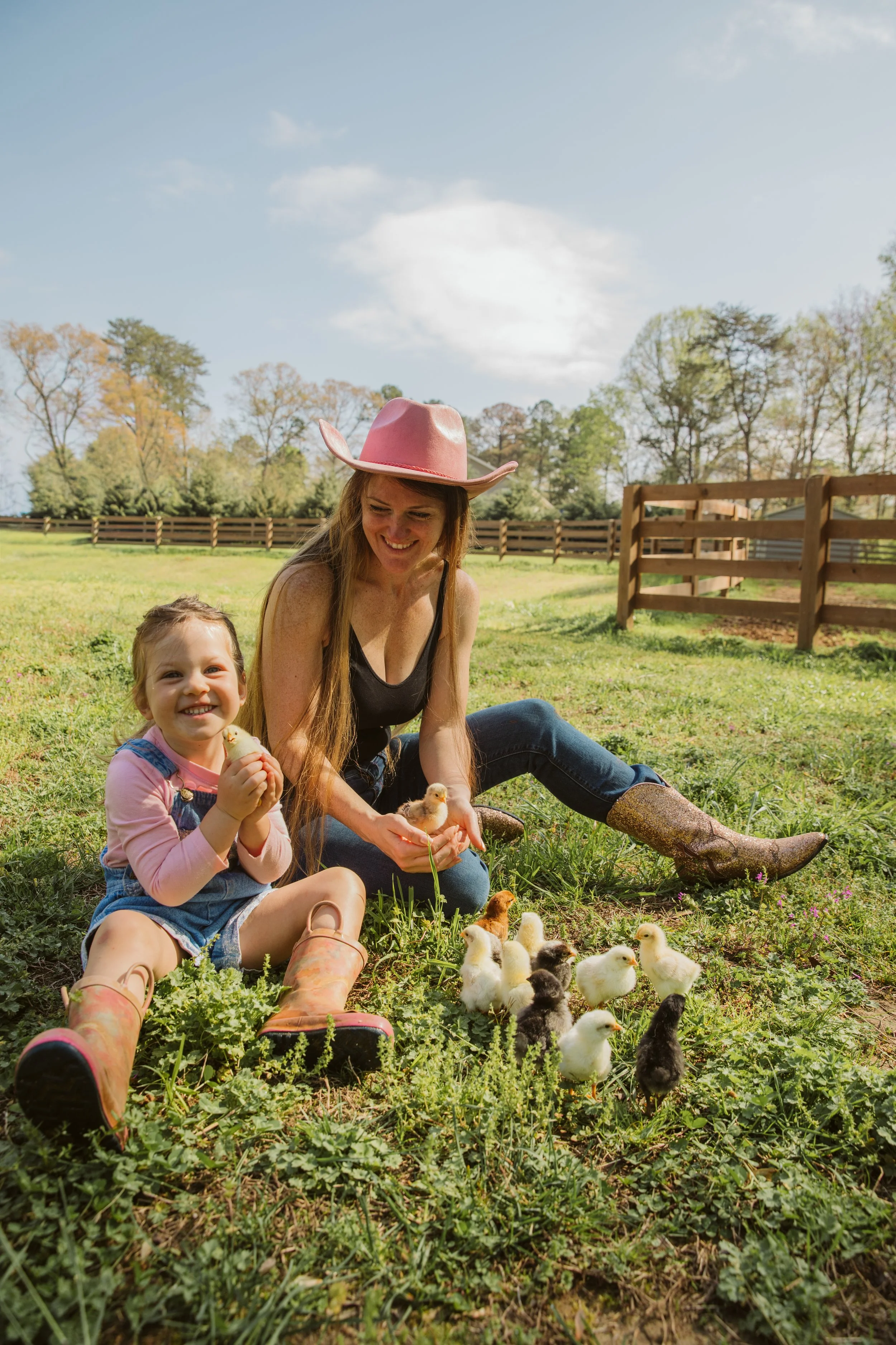 Smiling child with chicks in field