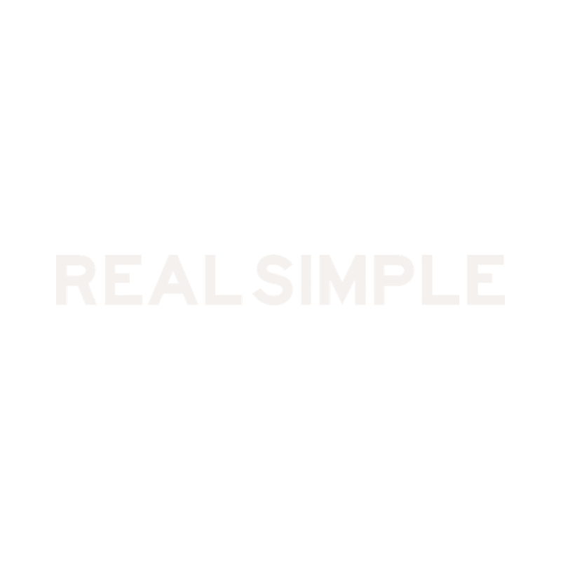 The image features a black background with a simple, minimalist white line drawing of a person holding a large spoon, along with the bold text 'REALSIMPLE' in uppercase white letters.