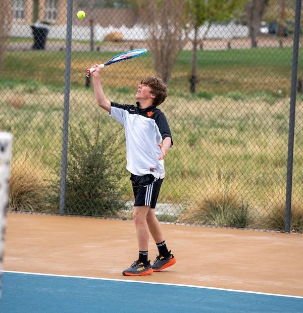 Tennis player hitting ball