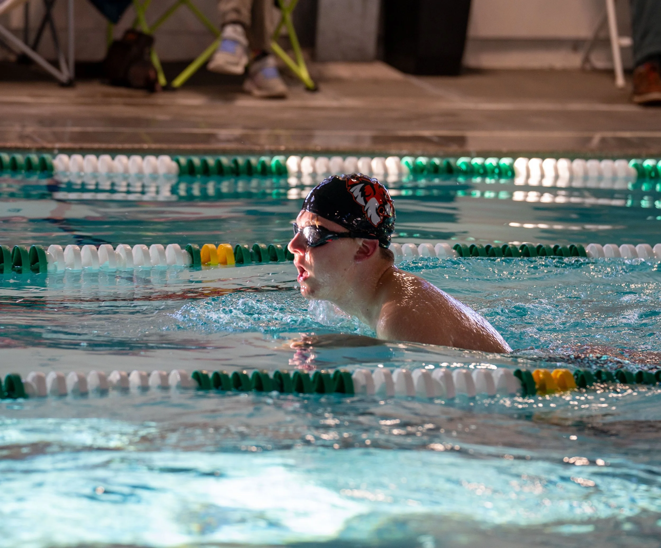 Swimmer doing laps with cap on