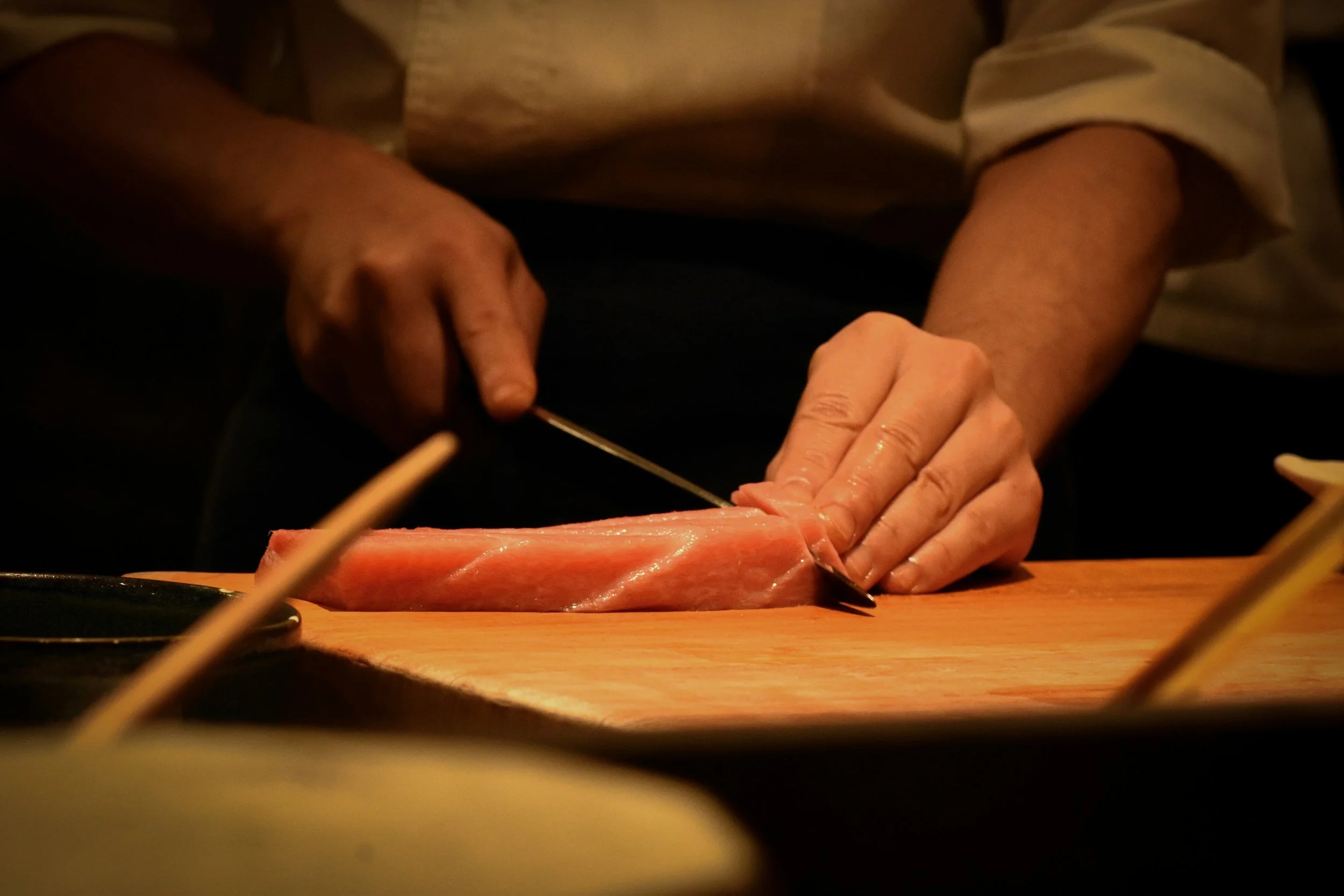 A chef slicing fish