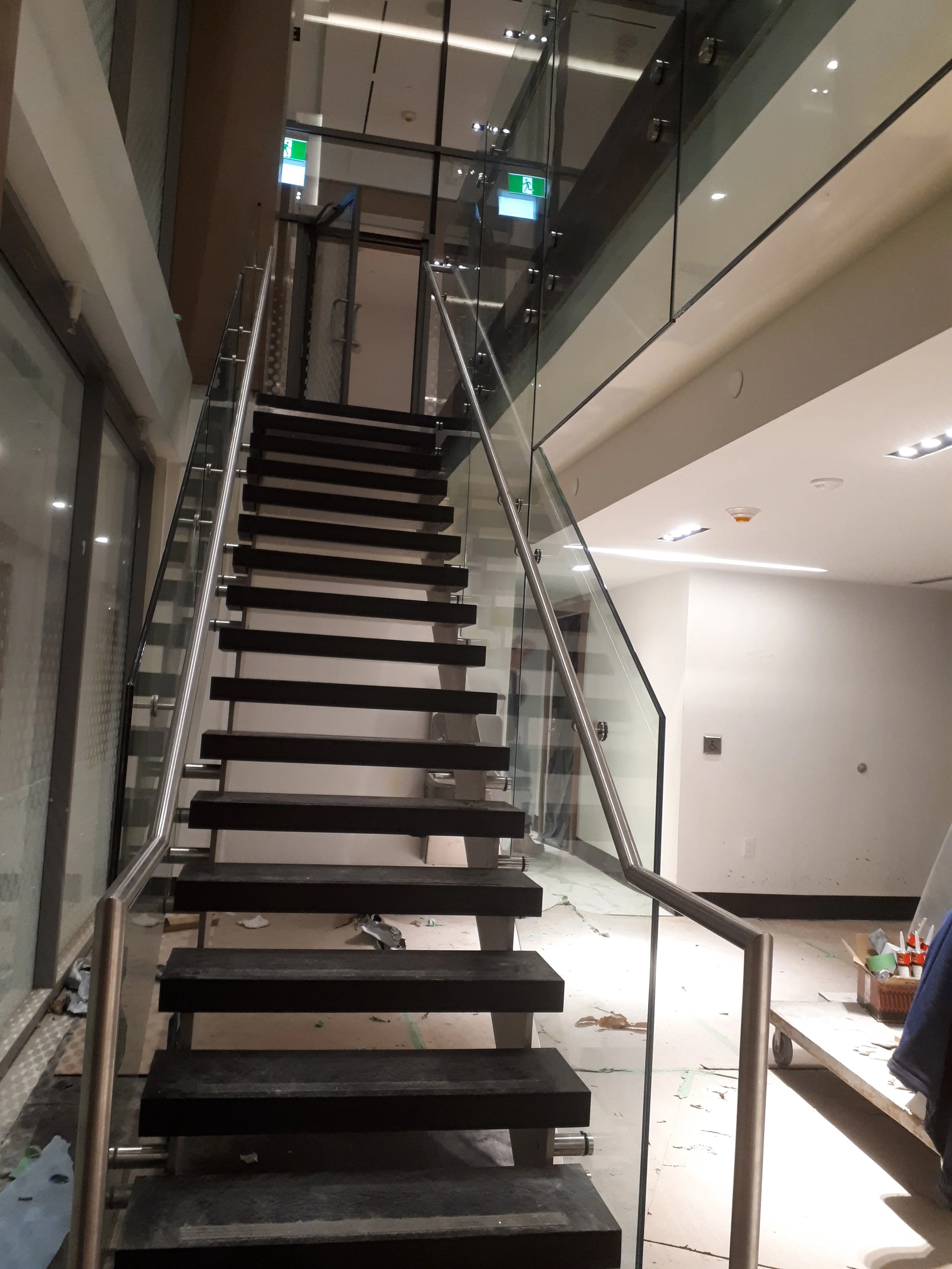 Stair and glass balustrades looking up.jpeg