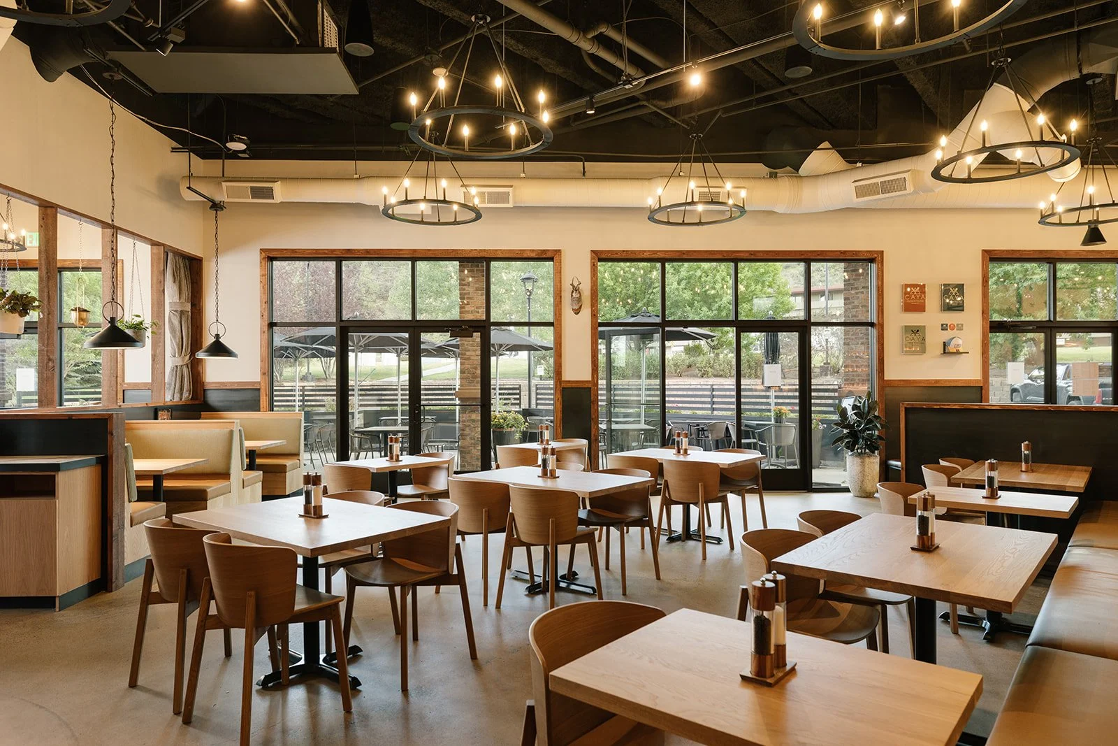 Shike Design transformed Caya Restaurant in Edwards, Colorado, with a refined mountain-modern interior featuring custom bar design, white oak, cedar, and dark steel.