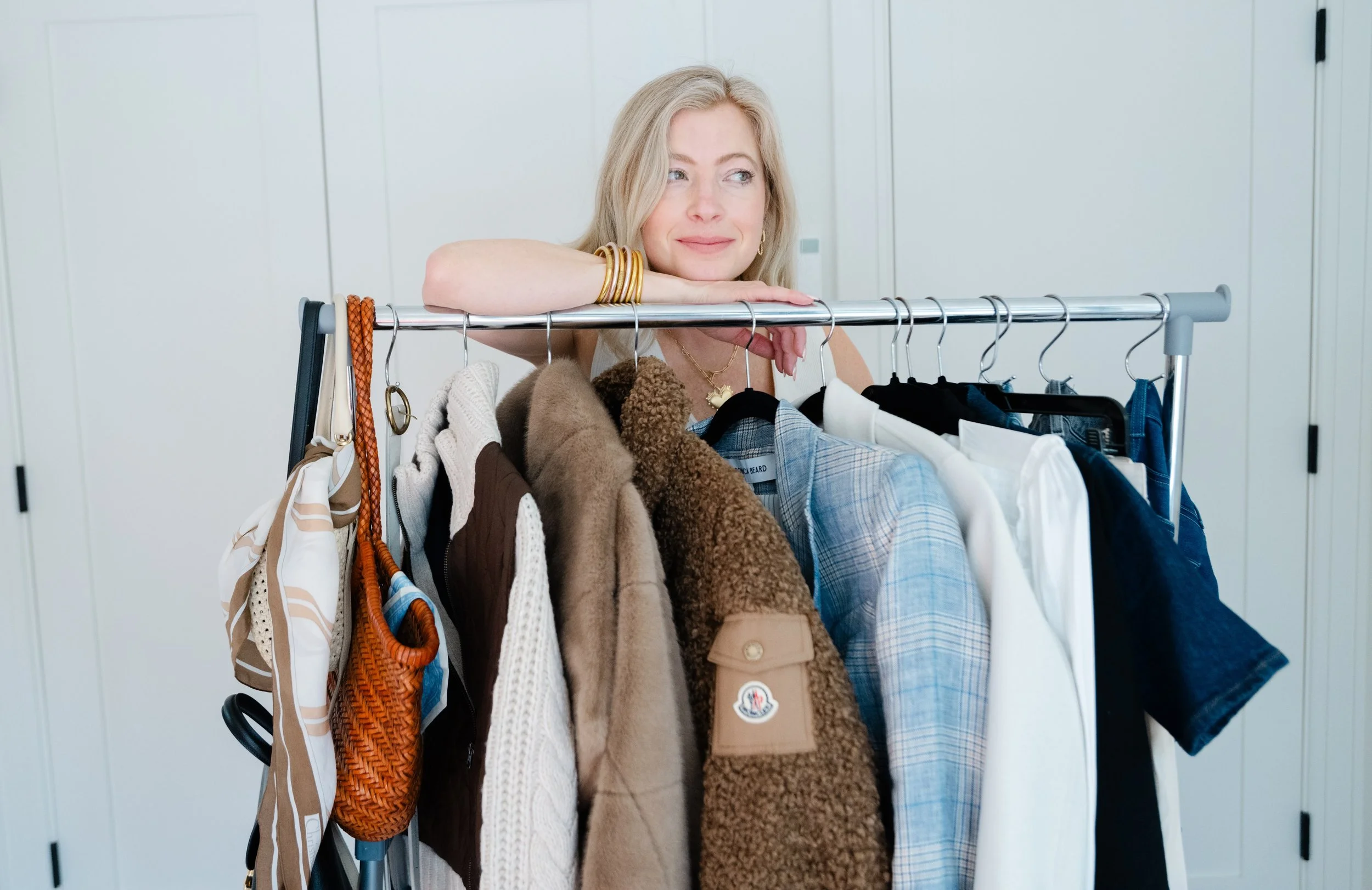 A professional stylist performing a tight closet edit for a client.