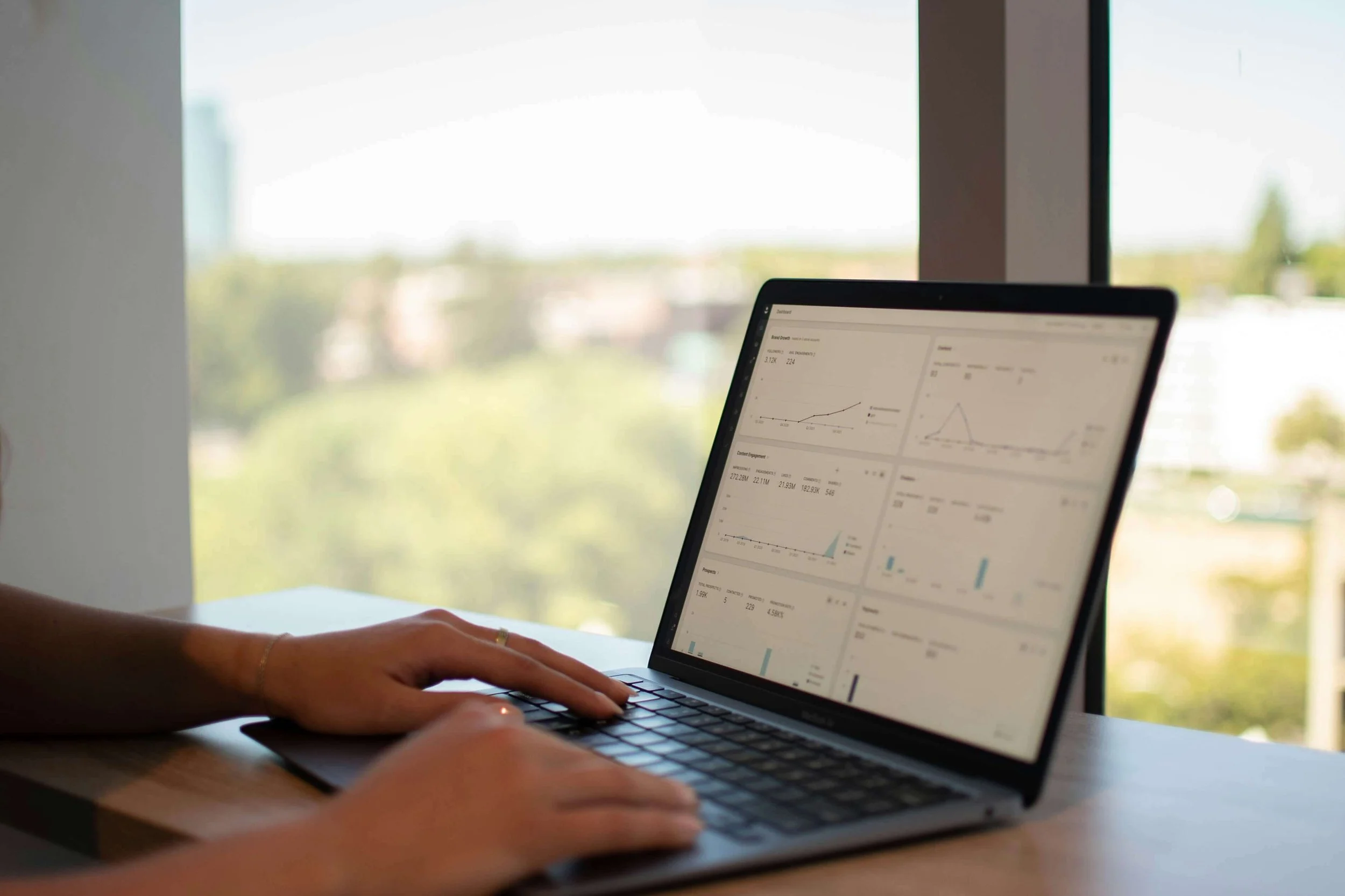 Person looking at marketing stats on laptop