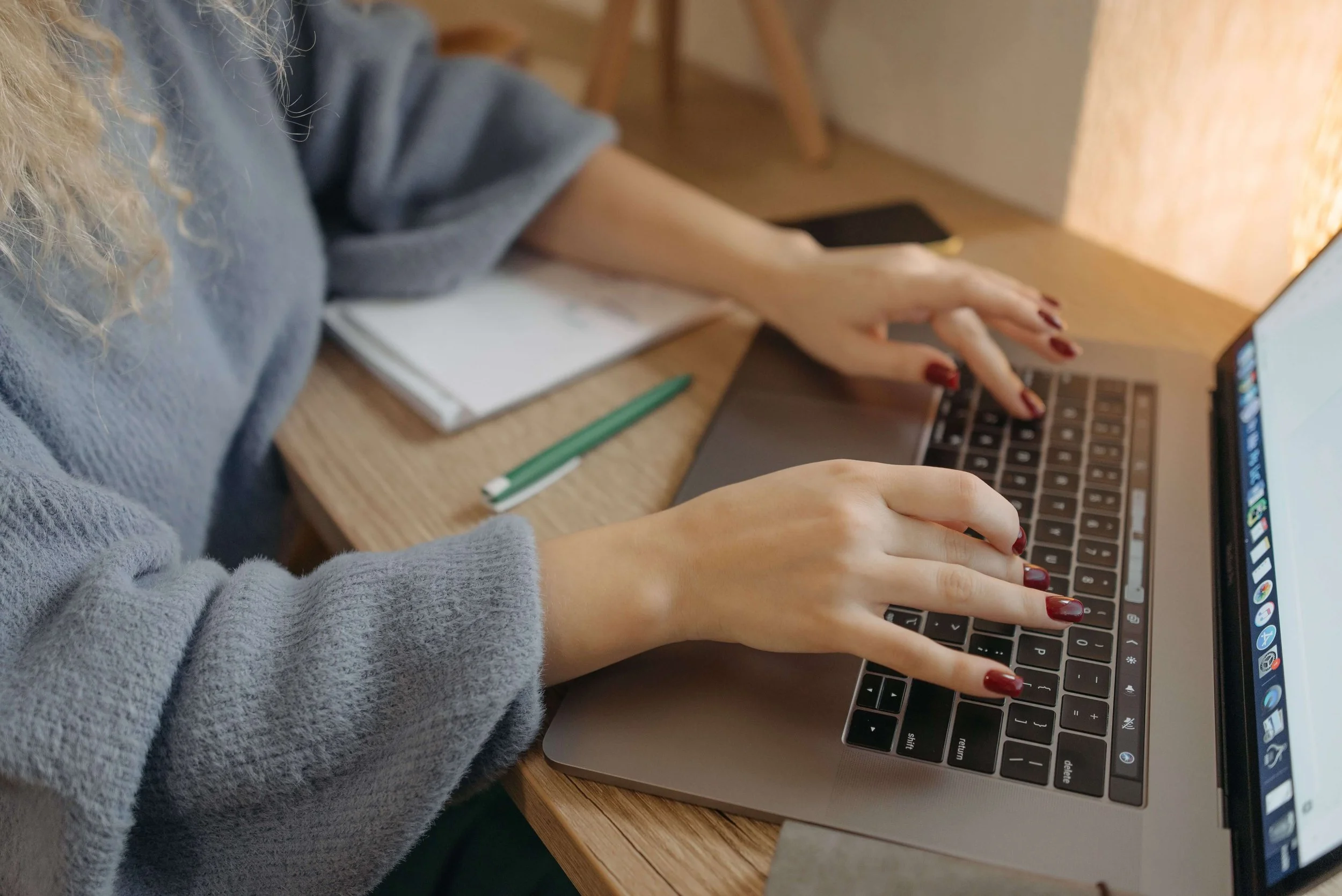 Marketer typing on a laptop while researching B2B fintech content and AI search strategy