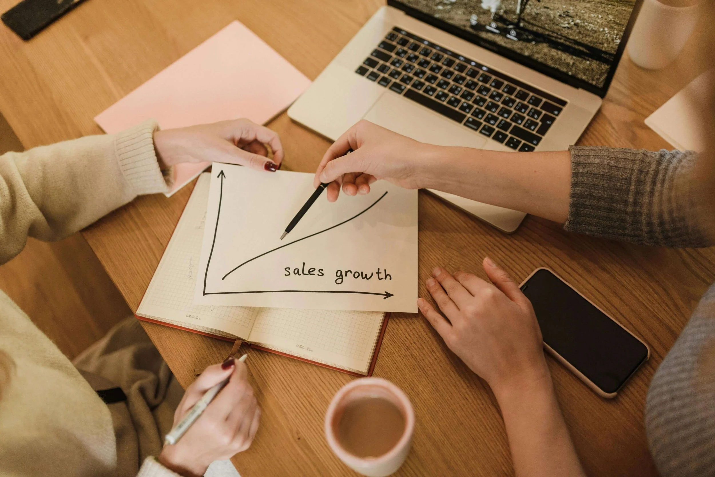 Marketing team looking at graph for sales growth