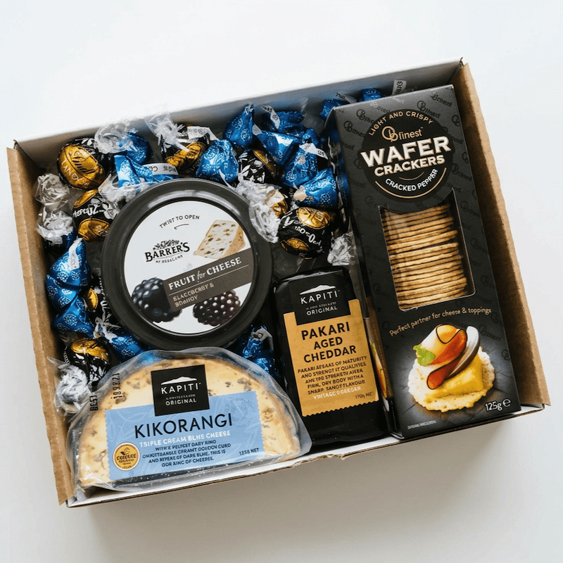 Gift tray with local Kapiti Kikorangi cheese, Pakari Aged Cheddar, Fruit Paste, Wafer Crackers, hershey kisses and lindt chocolates, delivery Levin.