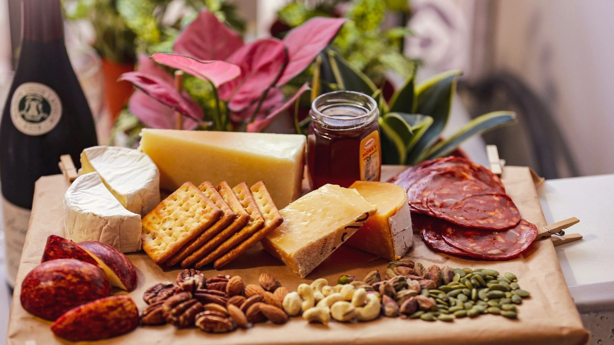 Assorted cheeses, crackers salami nuts on a serving board for gifts deivered across the Horowneua.