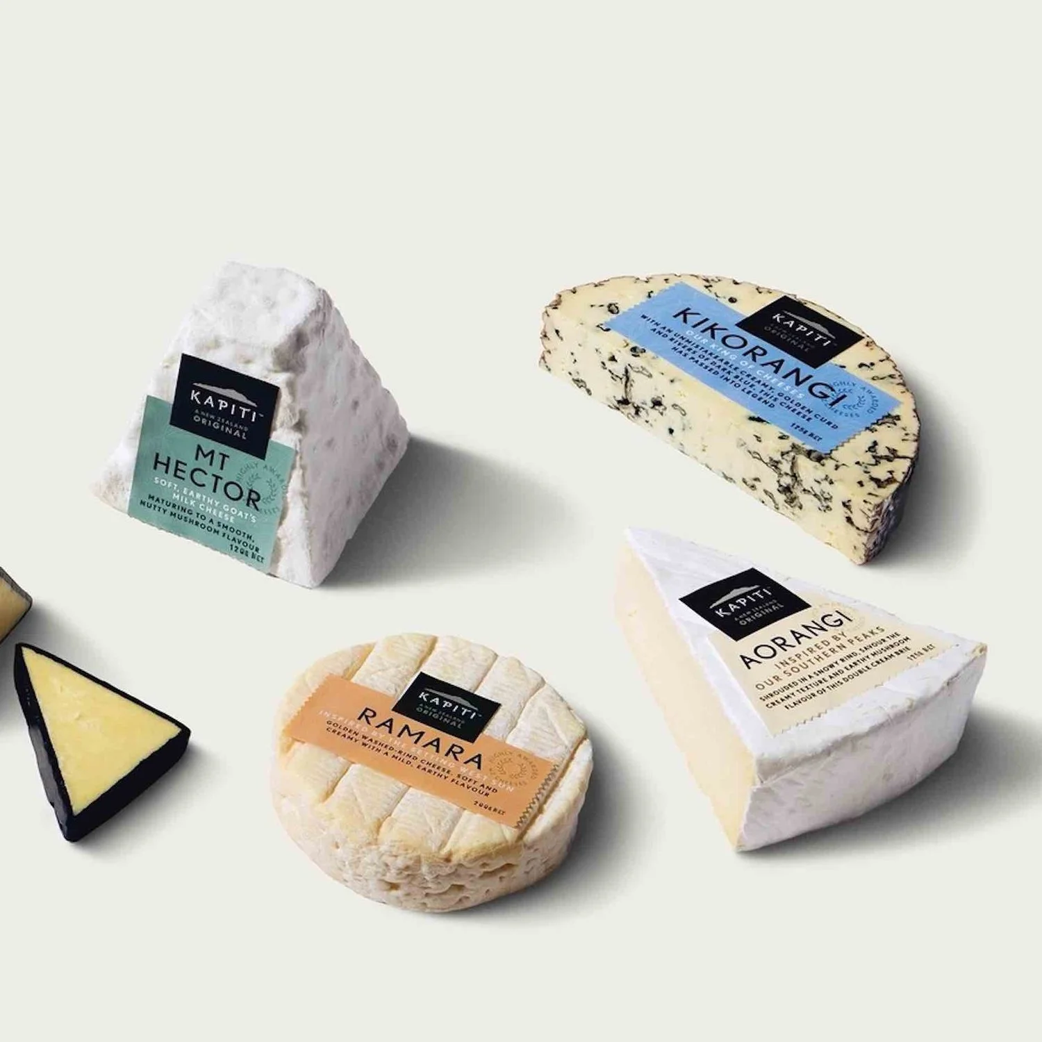 Assorted Kapiti gourmet cheeses displayed on a platter, representing options available in the Add Ons category.