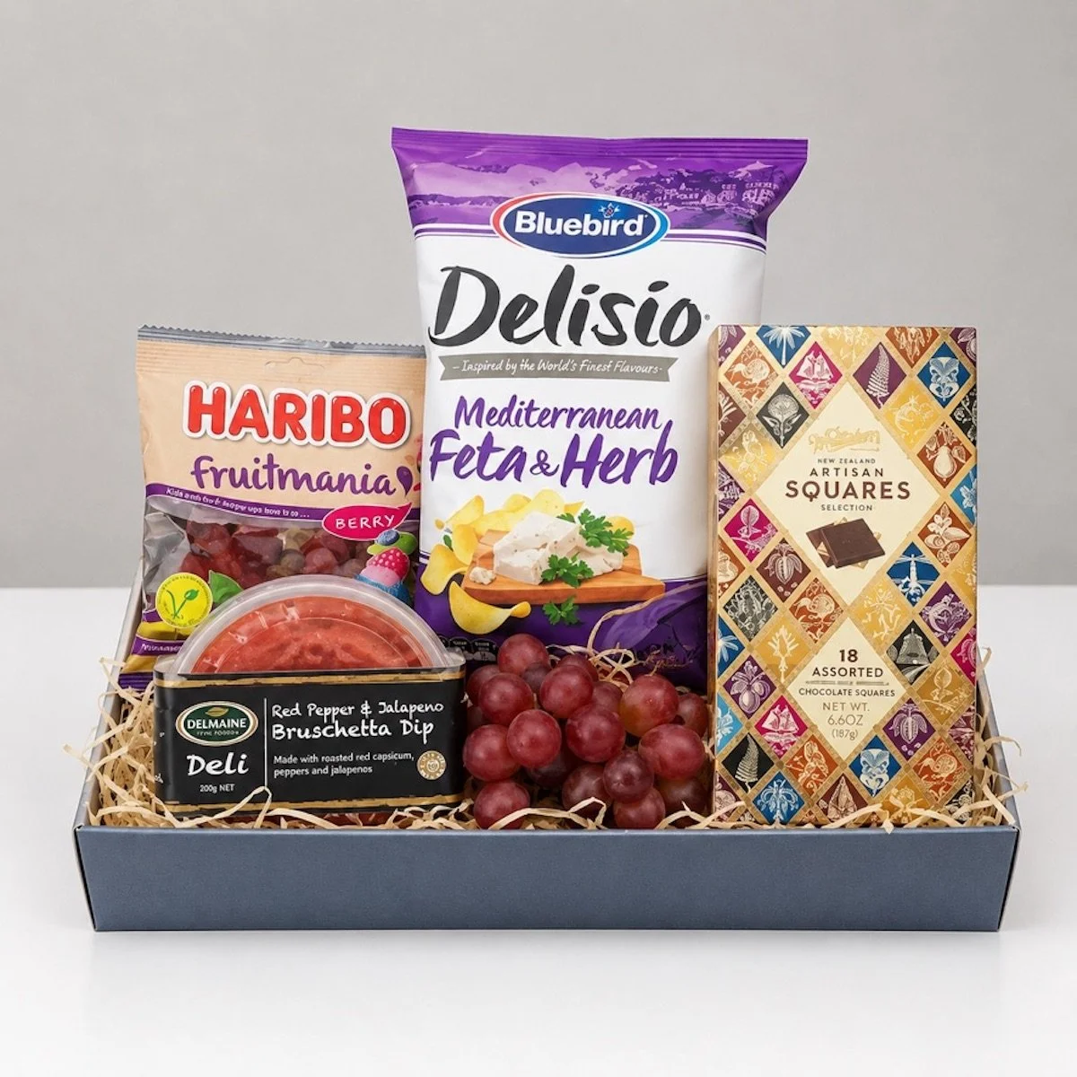 A savoury and sweet hamper with chocolates, dip, feta & herb chips and lolies, delivery Levin.