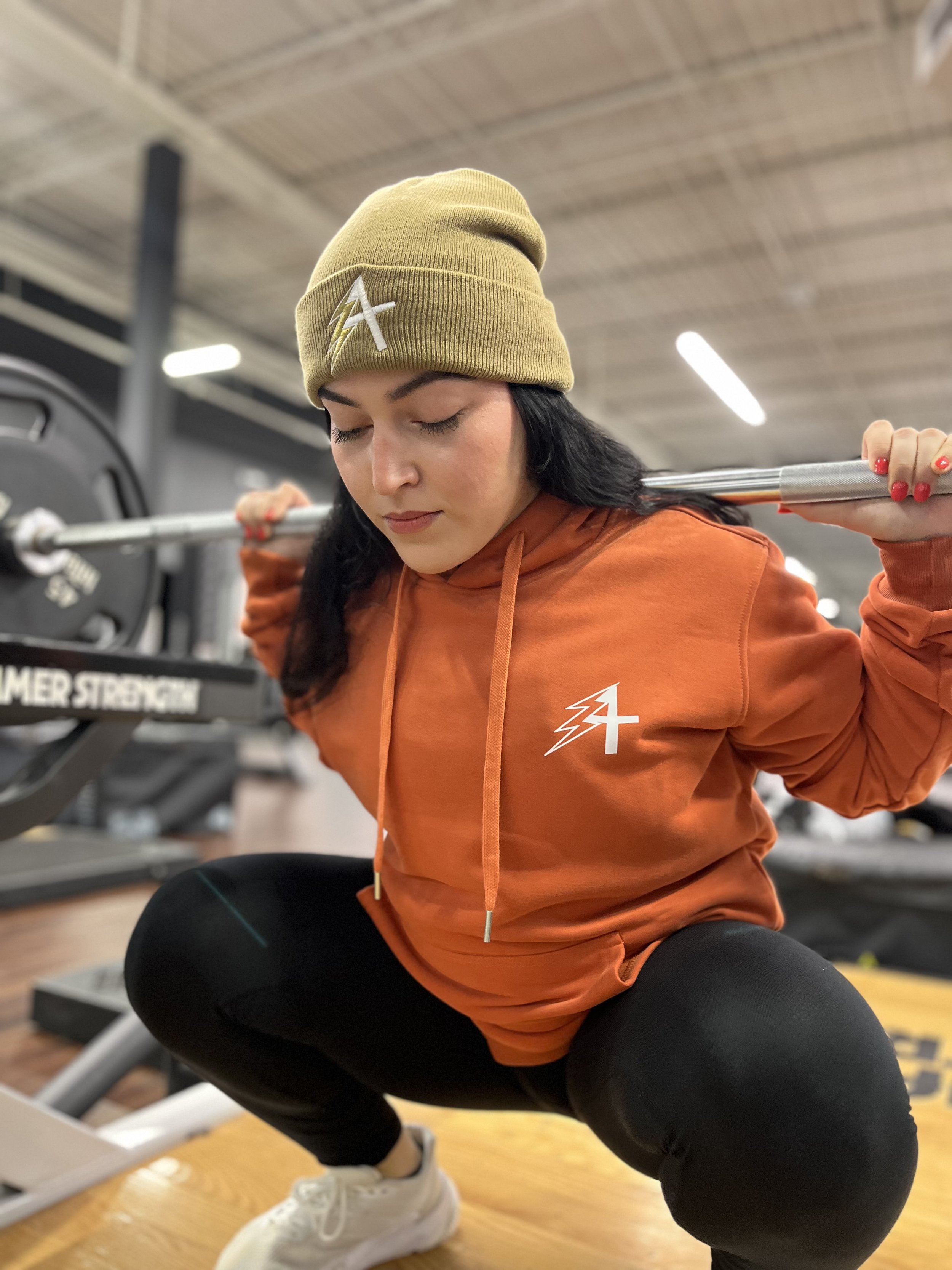 Mj Squatting orange hoodie.jpeg