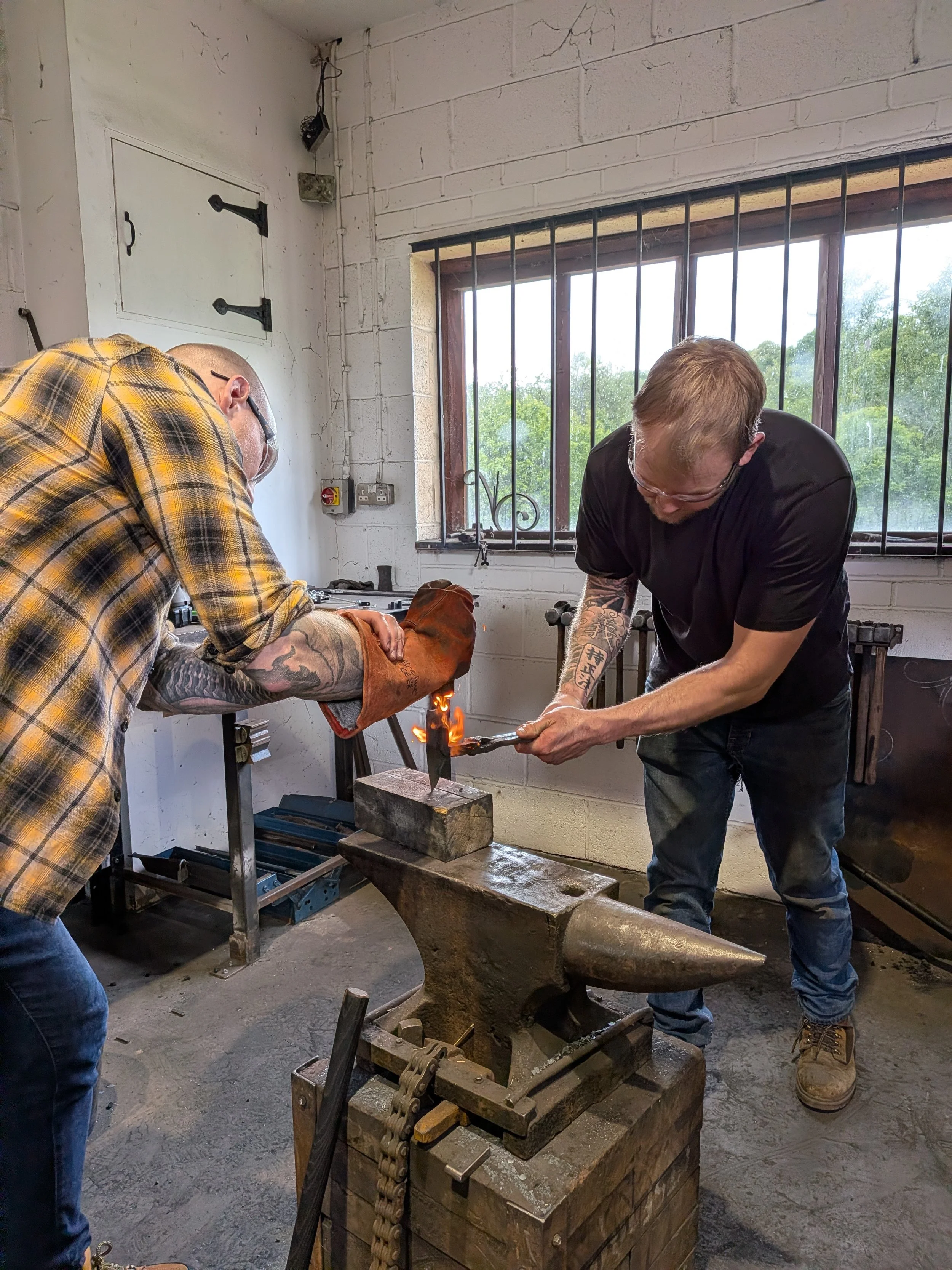 Burning on the handle of a knife on our knifemaking blacksmithing experience