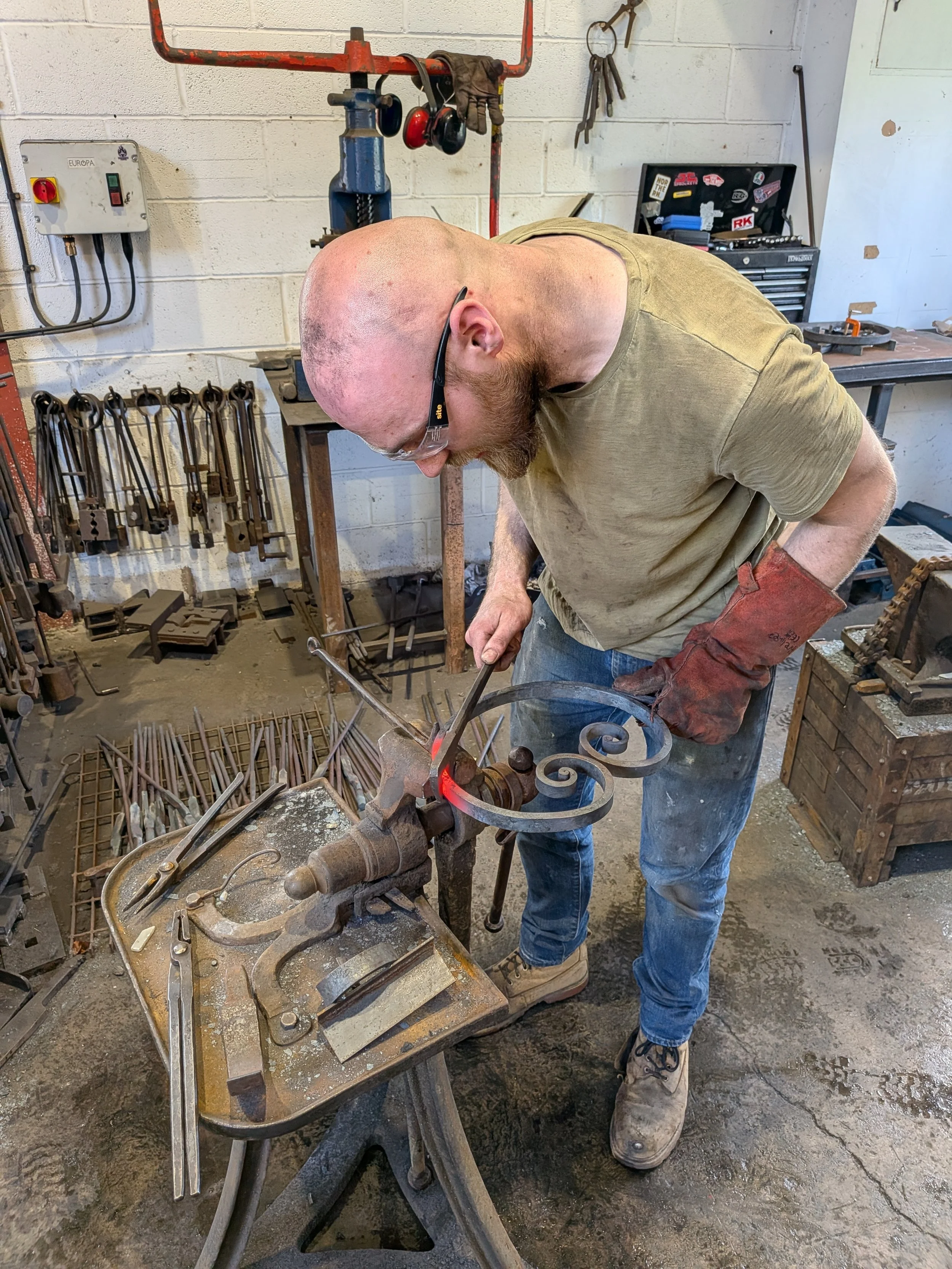 A blacksmith making a large scroll